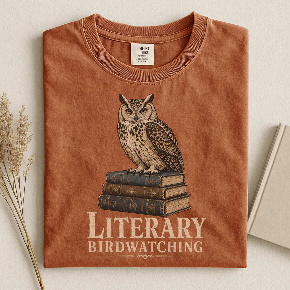 Shelf Love Studio Literary Birdwatching t-shirt in Yam, styled flat lay