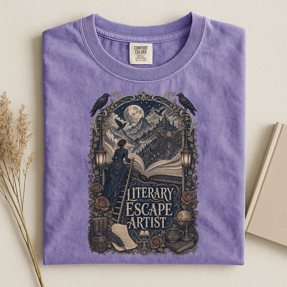 Literary Escape Artist bookish tee in Violet, flat lay