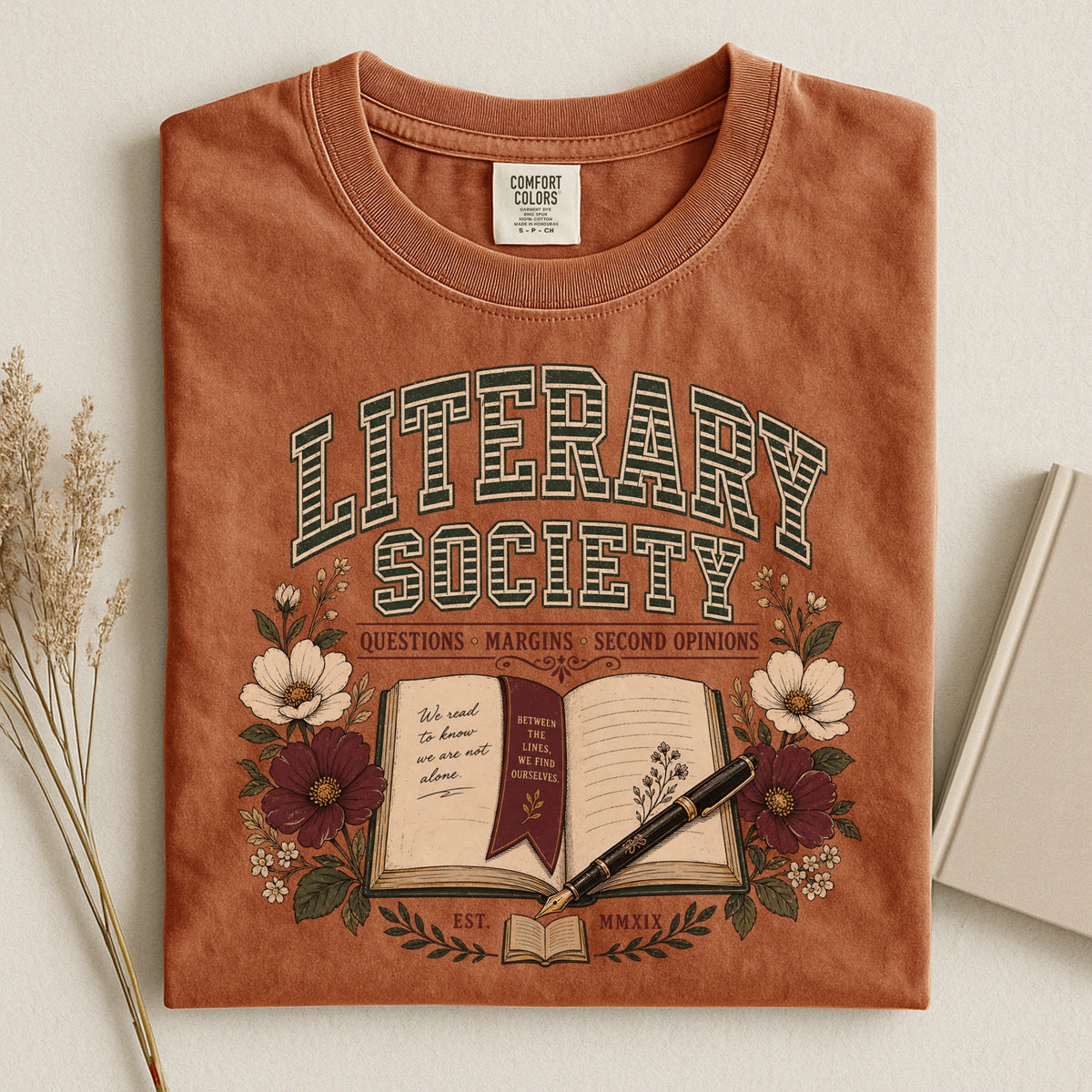 Shelf Love Studio Literary Society t-shirt in Yam, styled flat lay