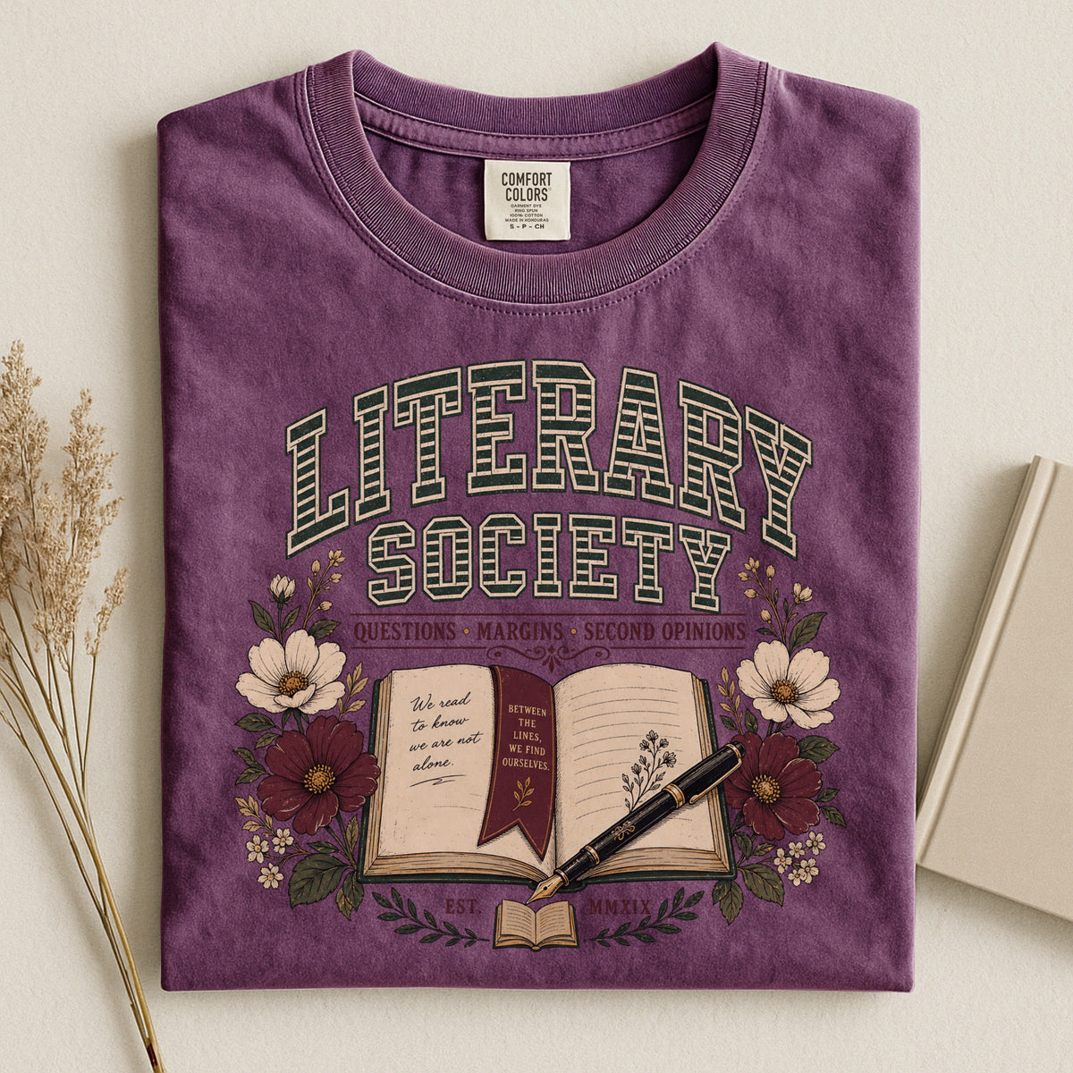 Shelf Love Studio Literary Society t-shirt in Berry, styled flat lay