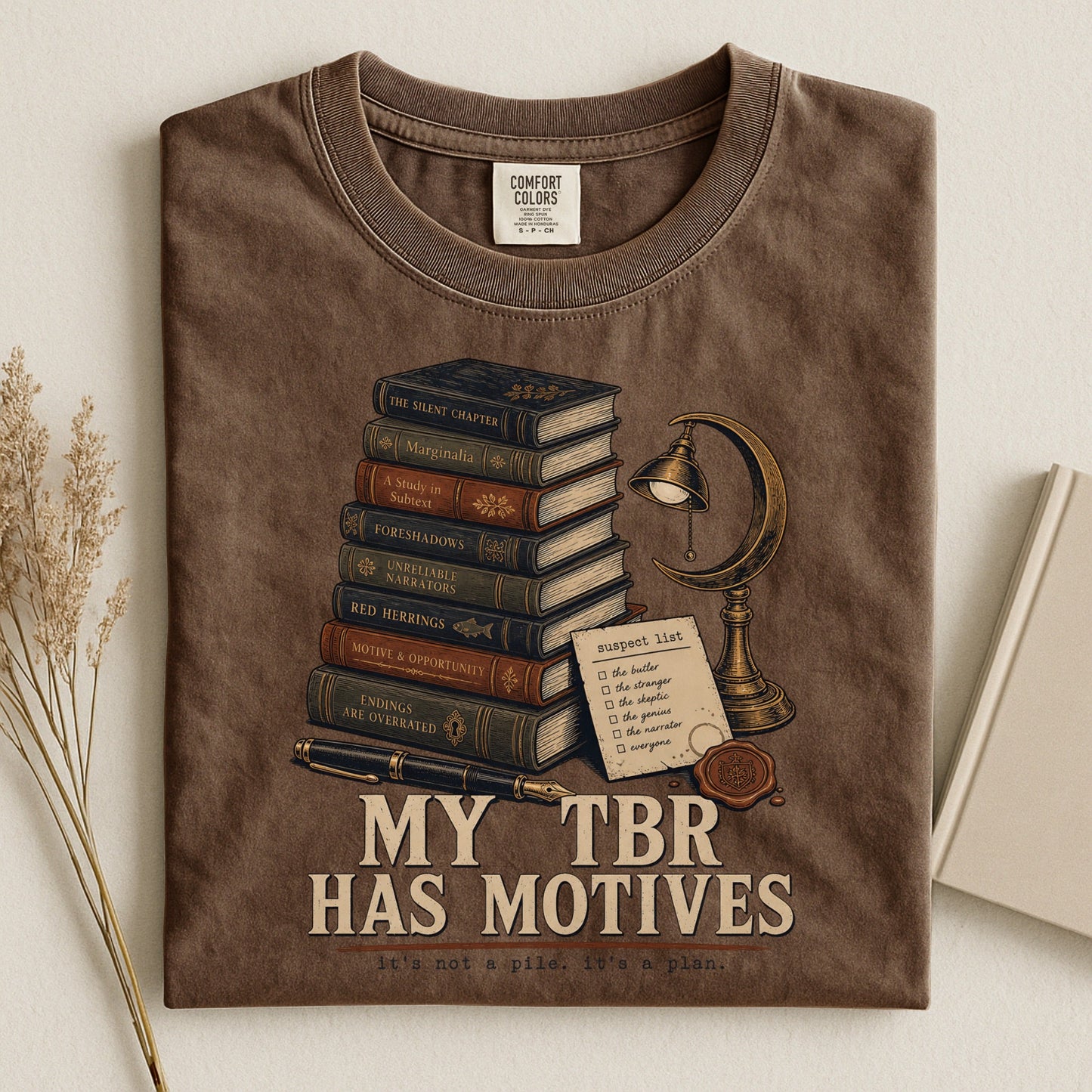 My TBR Has Motives bookish tee in Espresso, flat lay