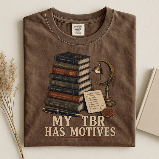 My TBR Has Motives bookish tee in Espresso, flat lay