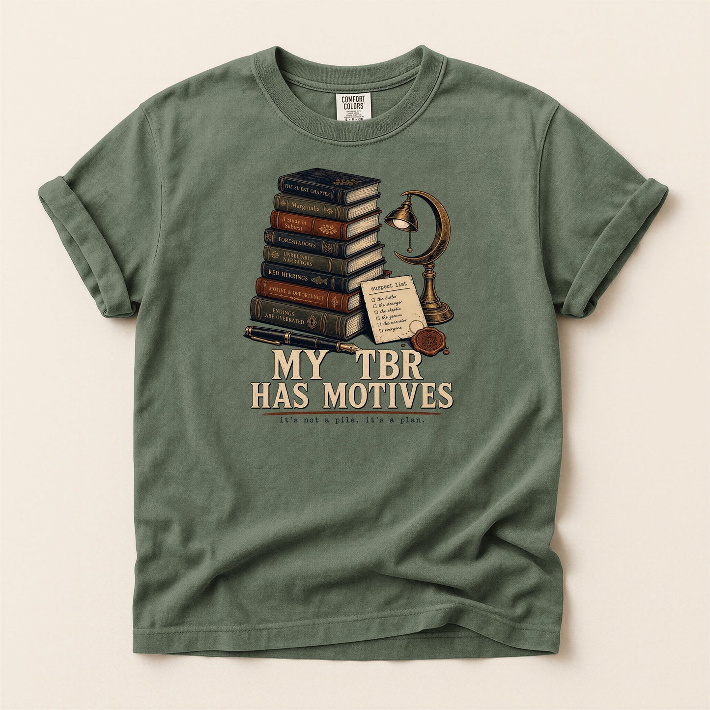 My TBR Has Motives bookish tee in Moss, full flat