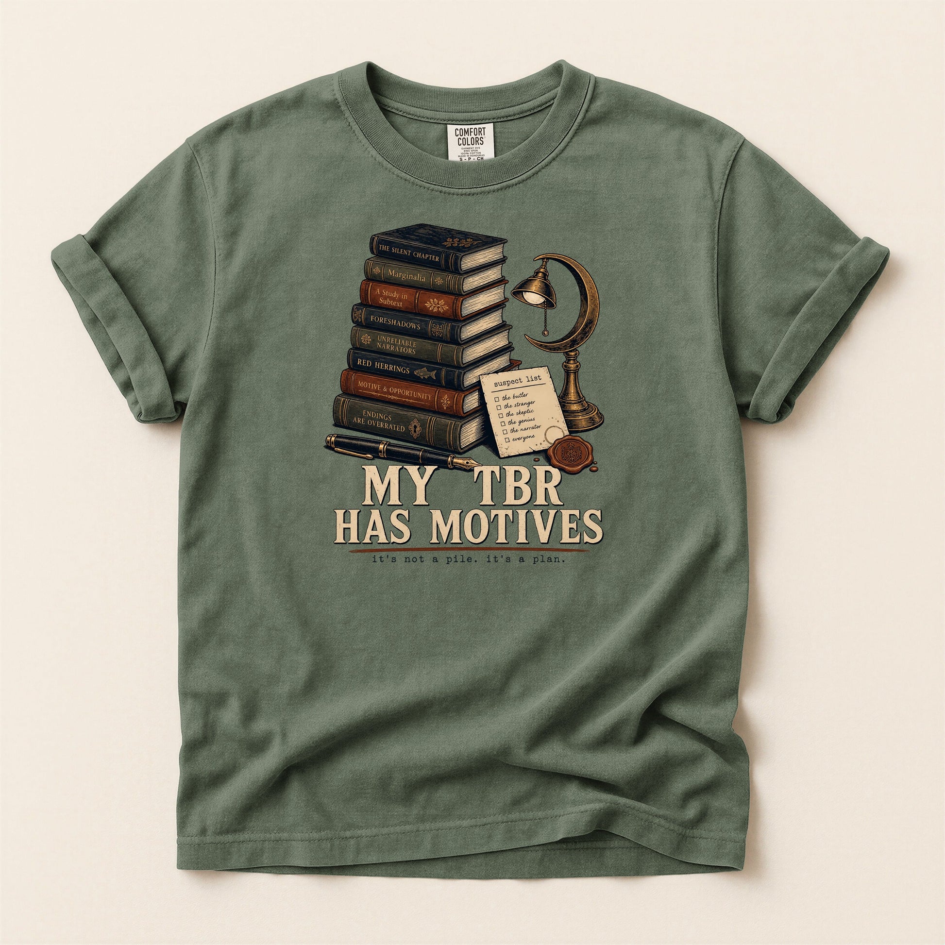 My TBR Has Motives bookish tee in Moss, full flat