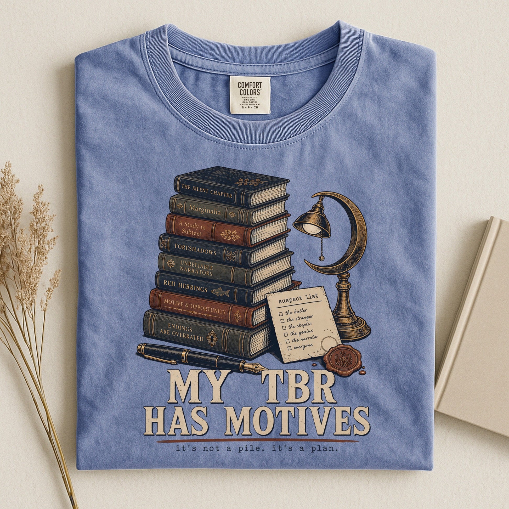 My TBR Has Motives bookish tee in Blue Jean, flat lay