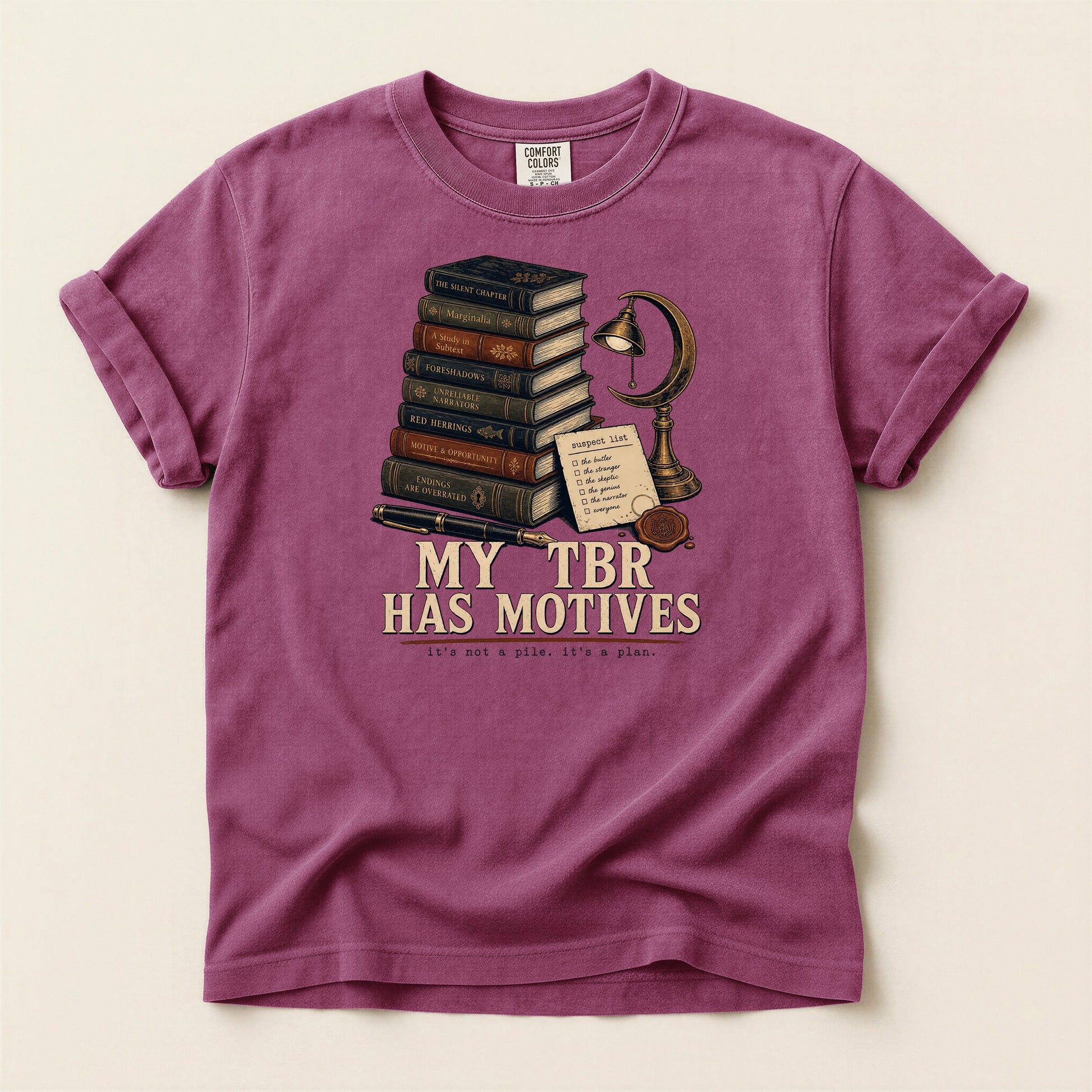 My TBR Has Motives bookish tee in Berry, full flat