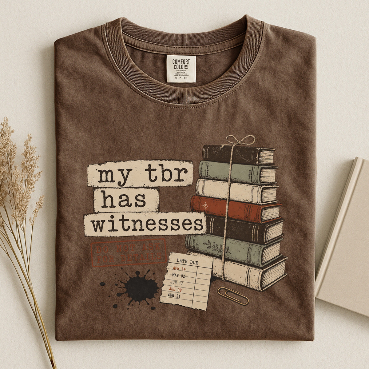 Shelf Love Studio My TBR Has Witnesses t-shirt in Espresso, styled flat lay