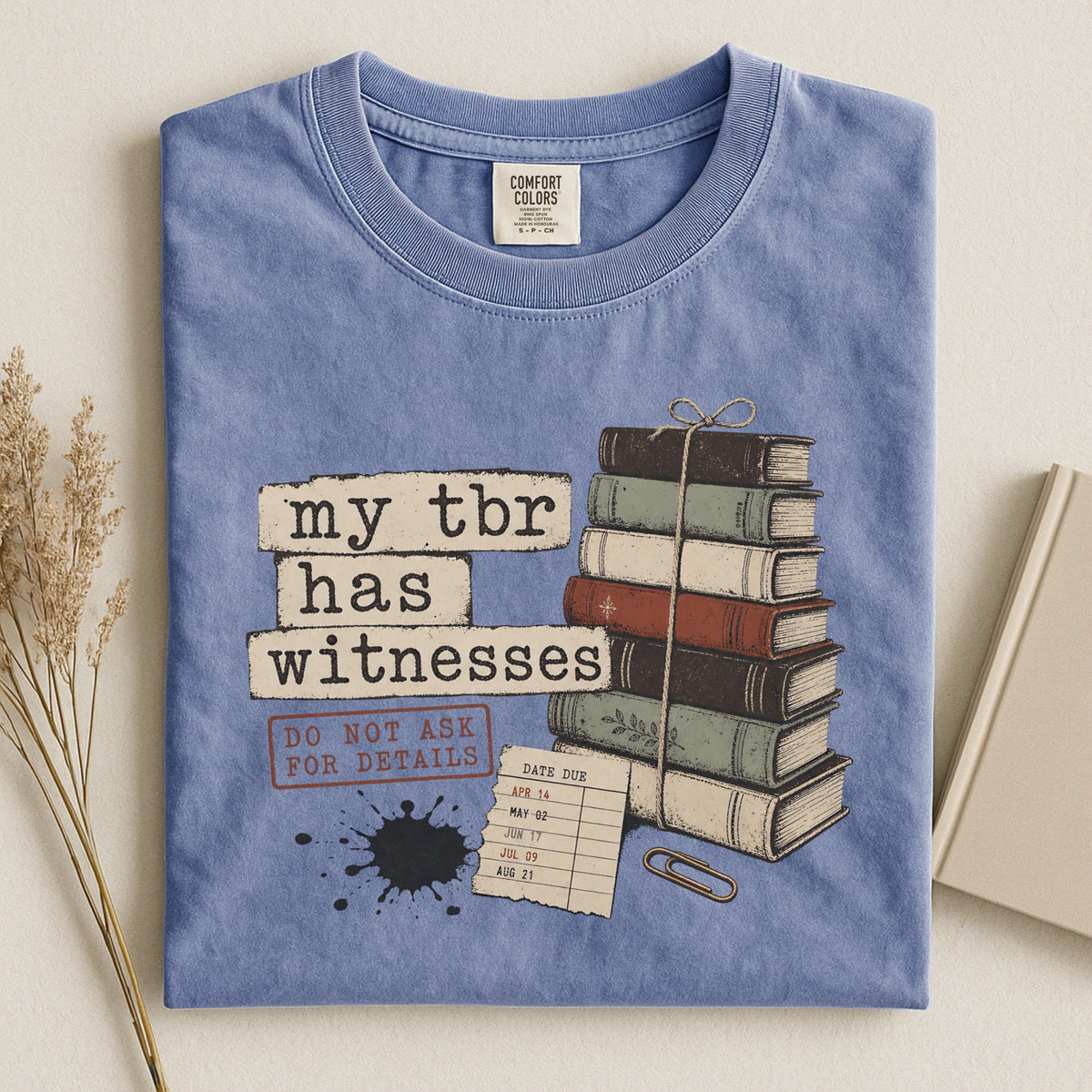 Shelf Love Studio My TBR Has Witnesses t-shirt in Blue Jean, styled flat lay