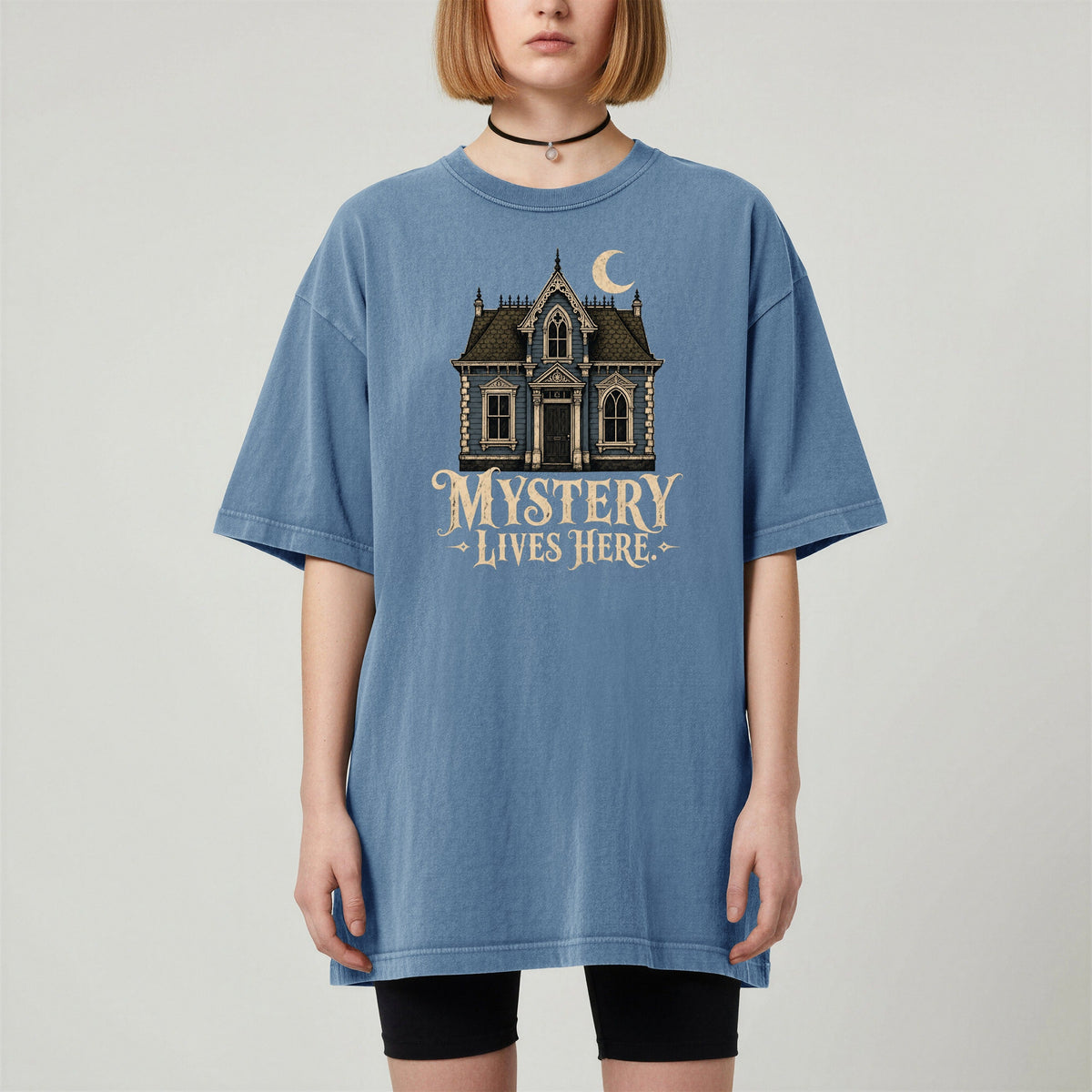 Shelf Love Studio Mystery Lives Here t-shirt in Blue Jean, worn