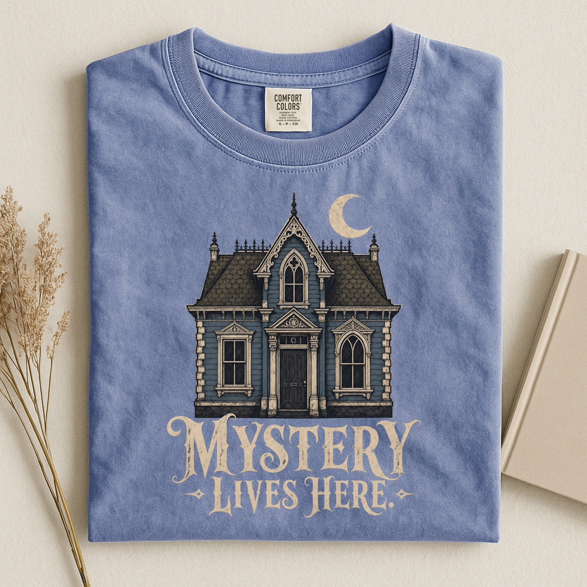 Shelf Love Studio Mystery Lives Here t-shirt in Blue Jean, styled flat lay
