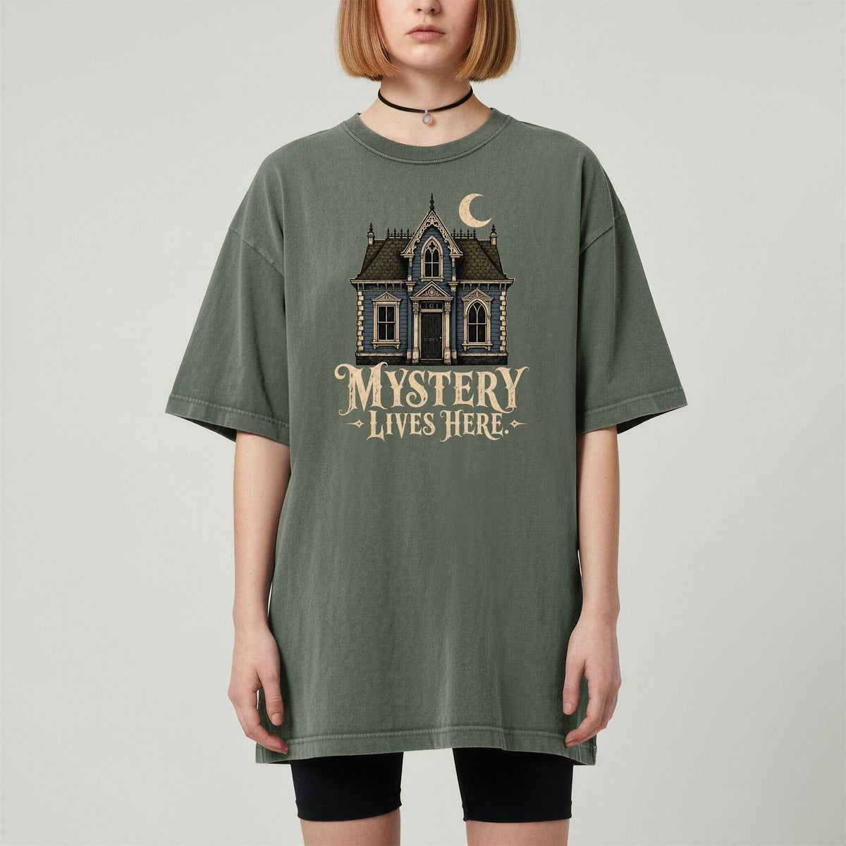 Shelf Love Studio Mystery Lives Here t-shirt in Moss, worn