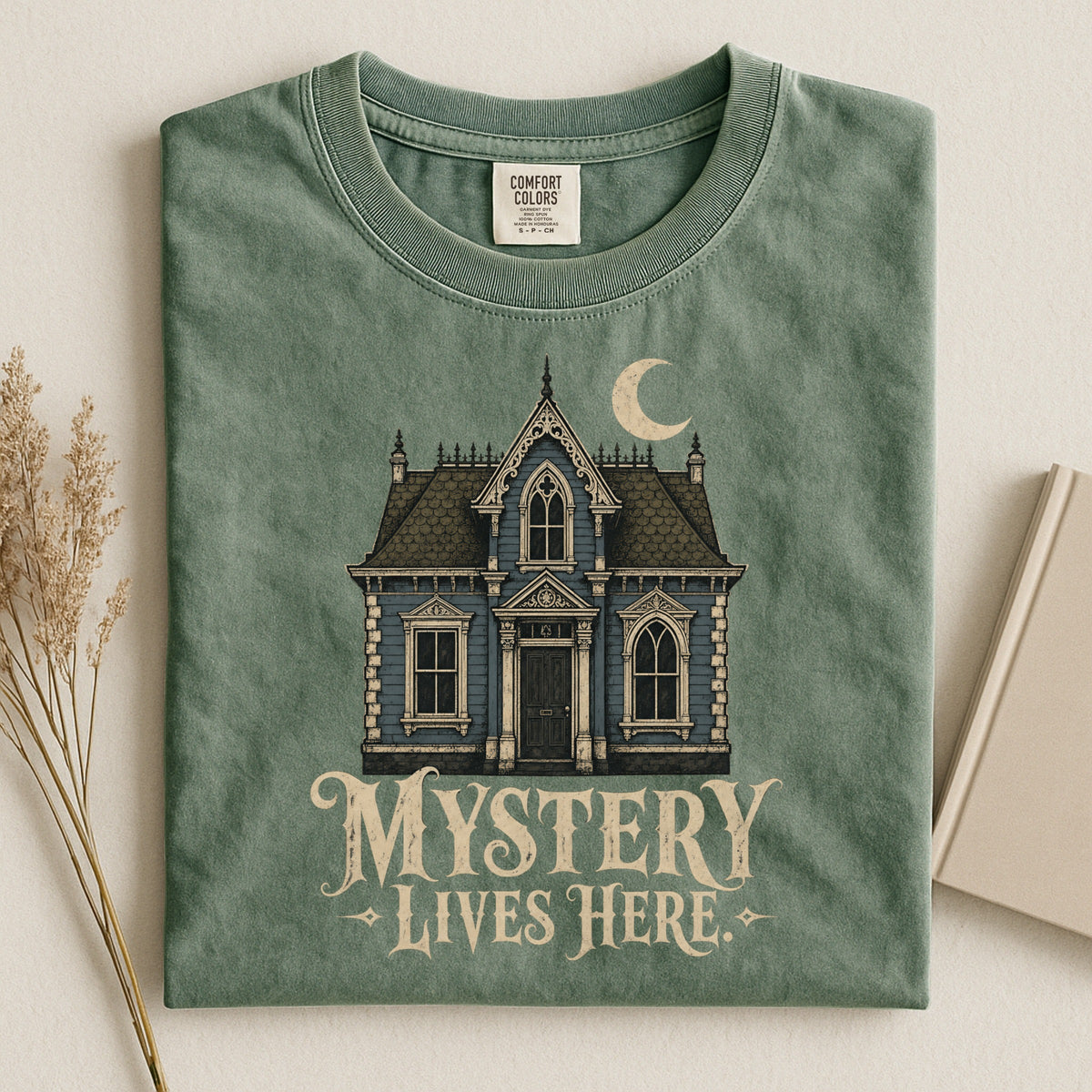 Shelf Love Studio Mystery Lives Here t-shirt in Moss, styled flat lay