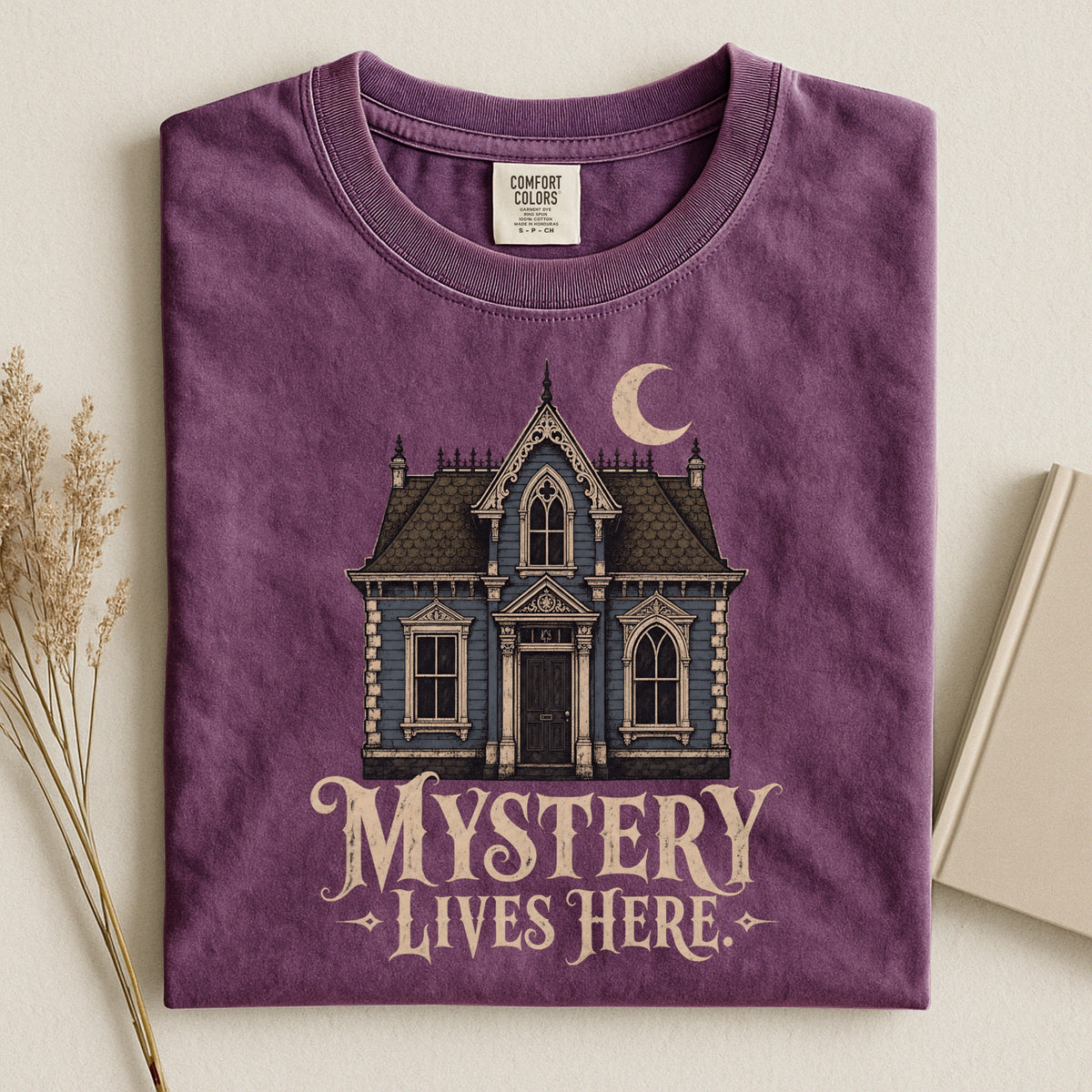 Shelf Love Studio Mystery Lives Here t-shirt in Berry, styled flat lay