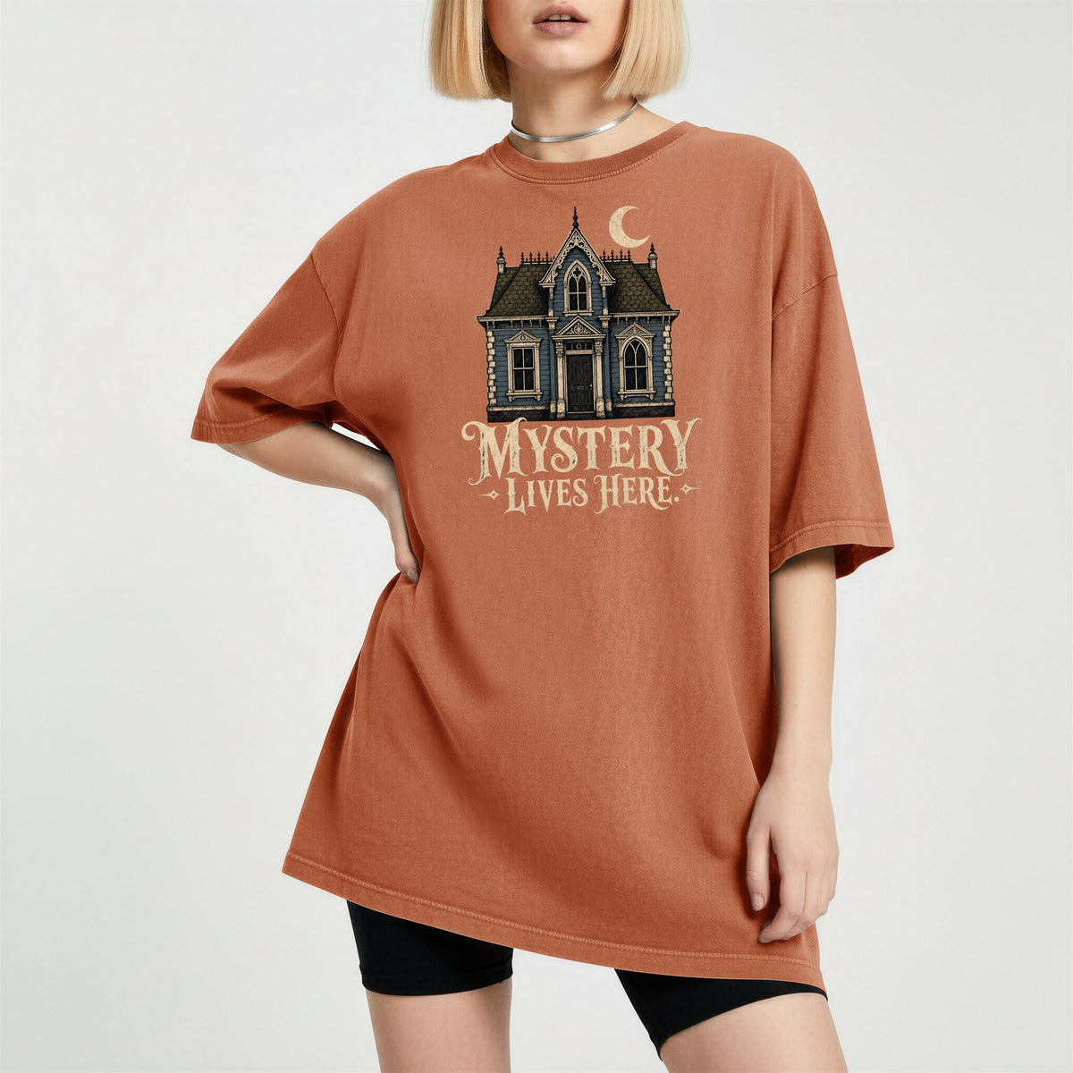 Shelf Love Studio Mystery Lives Here t-shirt in Yam, worn