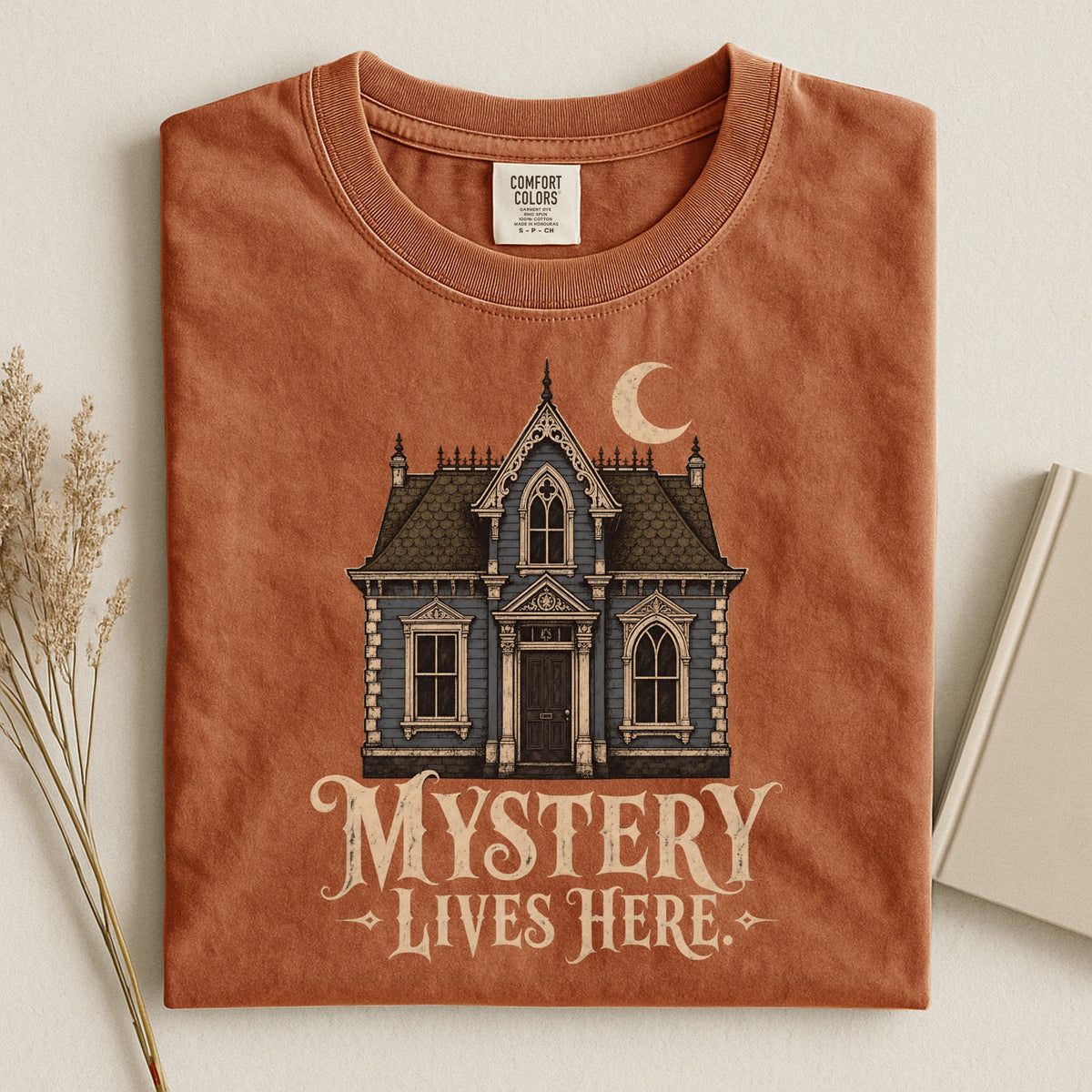 Shelf Love Studio Mystery Lives Here t-shirt in Yam, styled flat lay