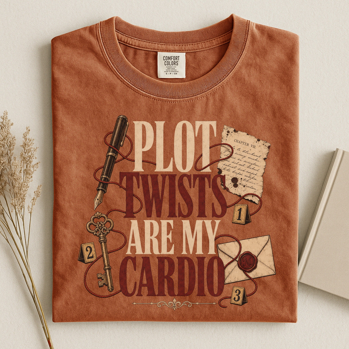 Shelf Love Studio Plot Twists Are My Cardio t-shirt in Yam, styled flat lay