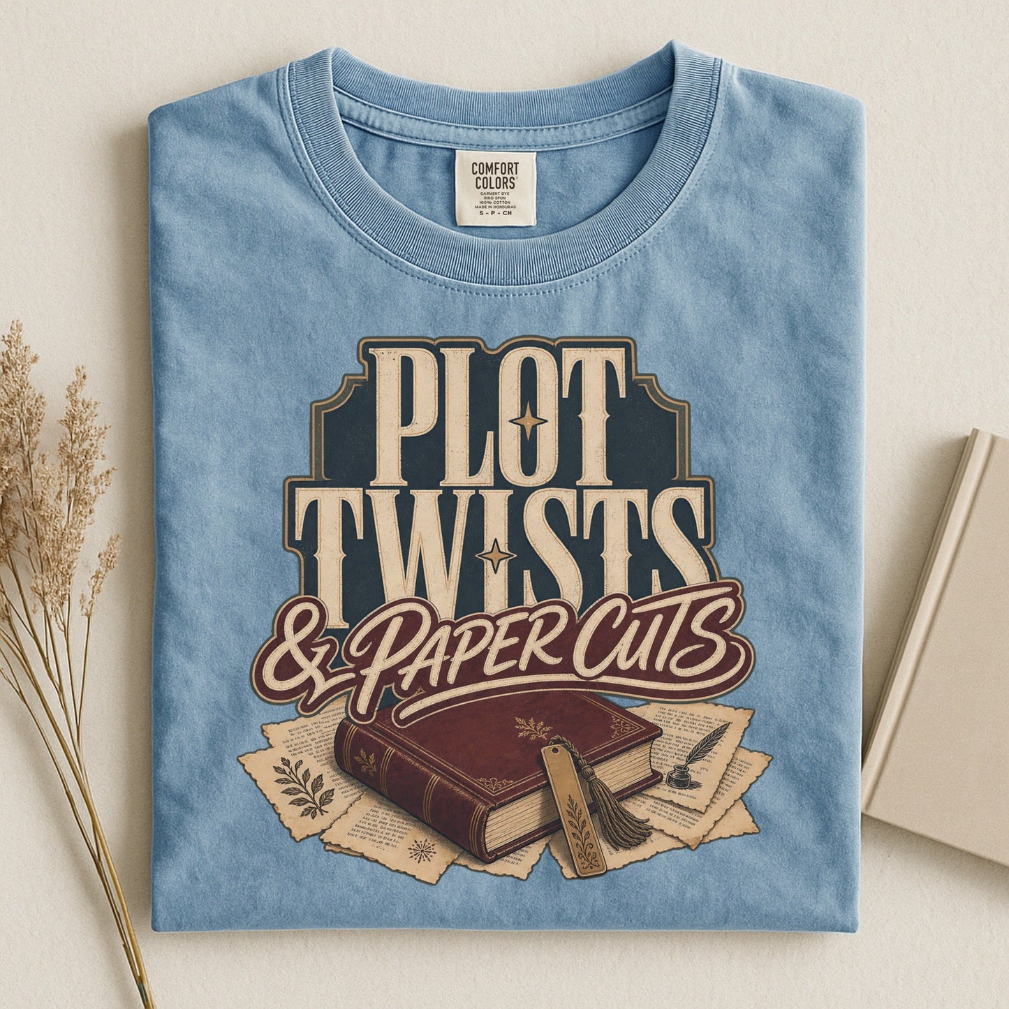 Plot Twists & Paper Cuts bookish tee in Ice Blue, flat lay