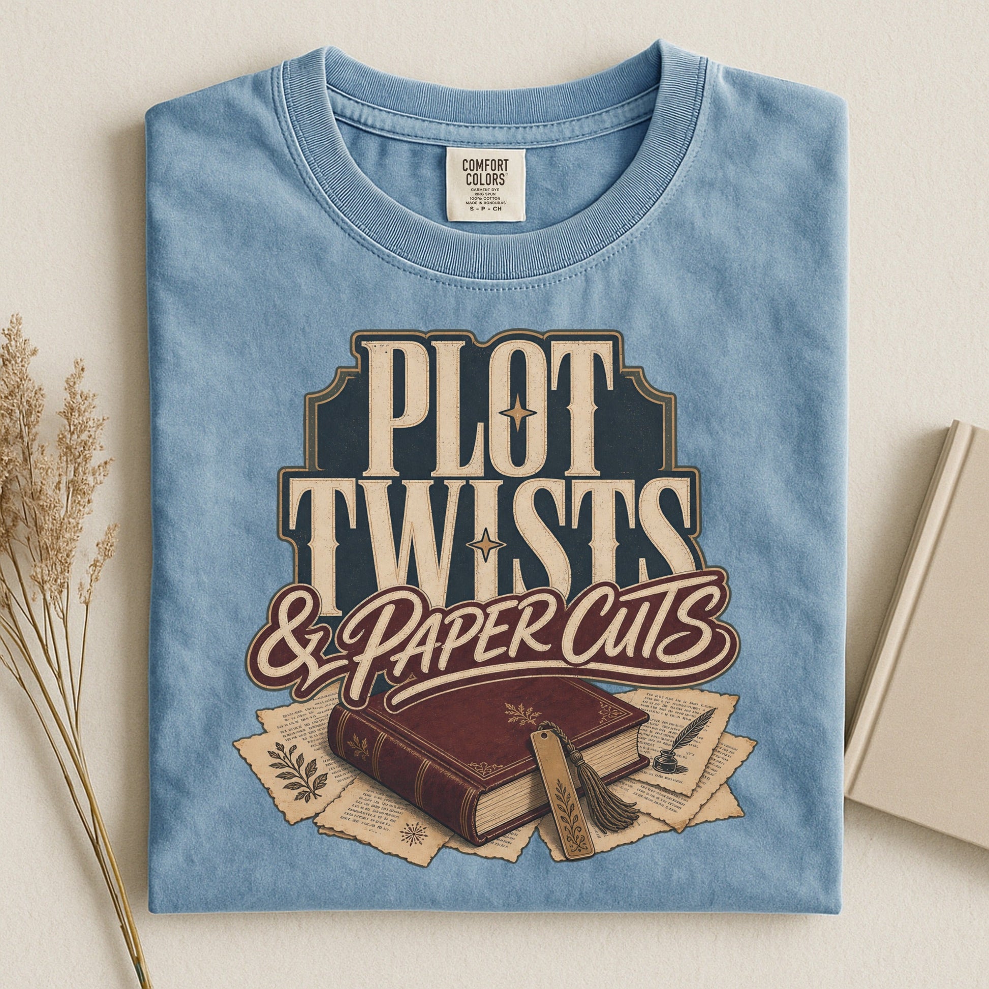 Plot Twists & Paper Cuts bookish tee in Ice Blue, flat lay
