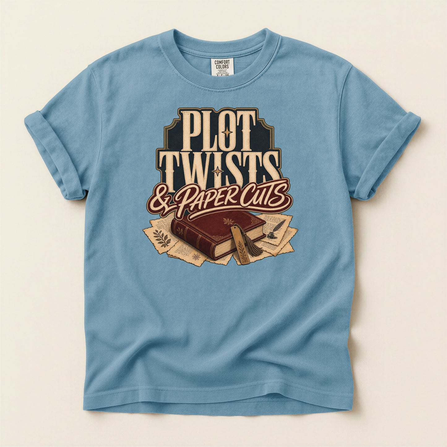 Plot Twists & Paper Cuts bookish tee in Ice Blue, full flat