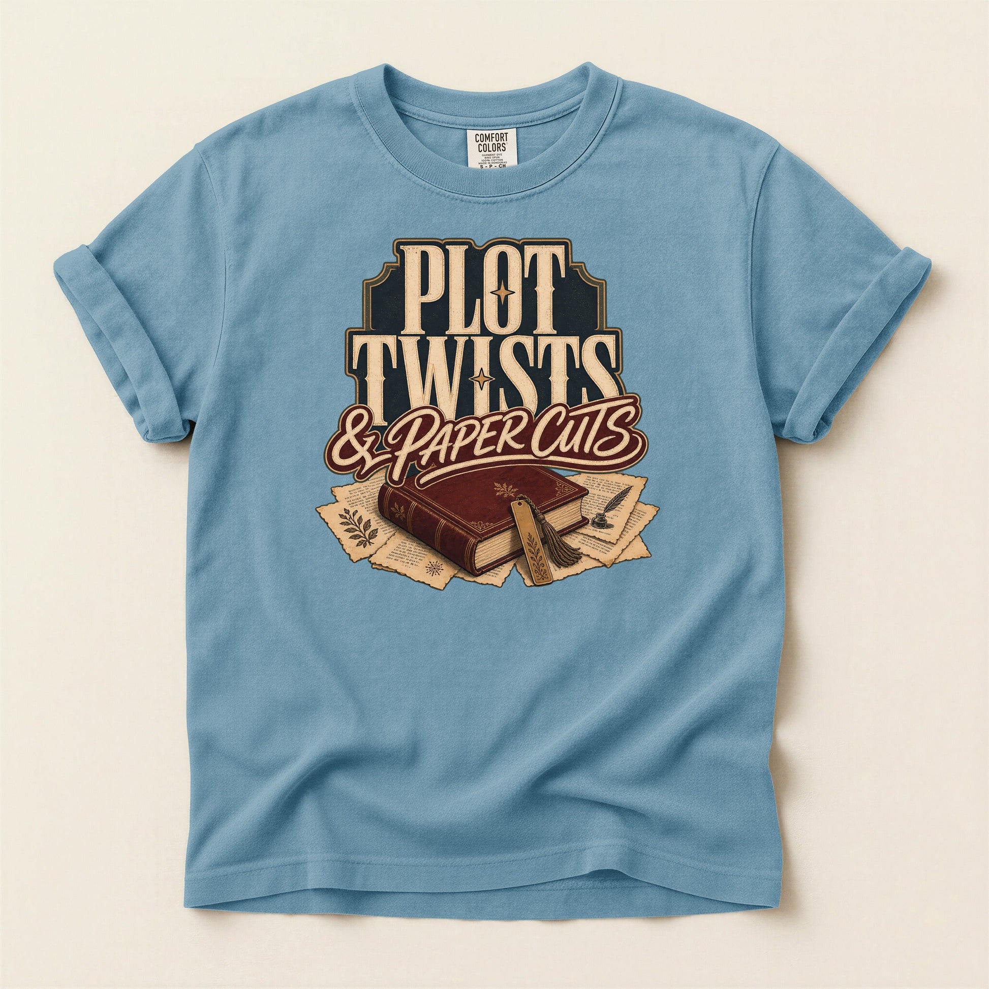 Plot Twists & Paper Cuts bookish tee in Ice Blue, full flat