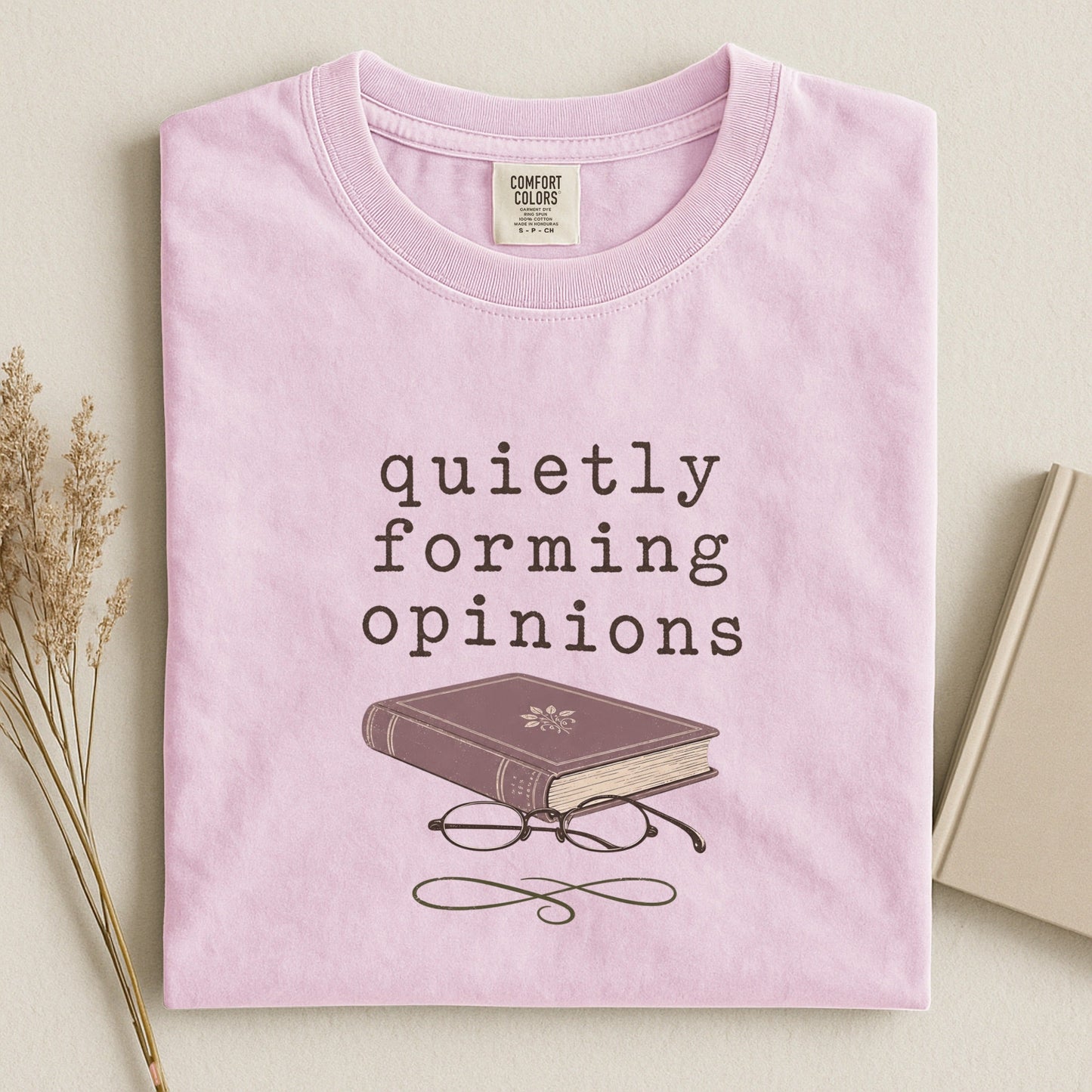Quietly Forming Opinions bookish tee in Blossom, flat lay