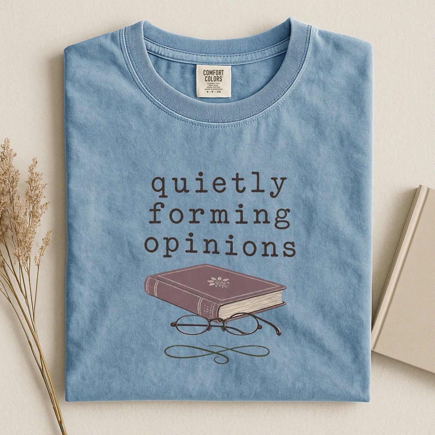 Quietly Forming Opinions bookish tee in Ice Blue, flat lay