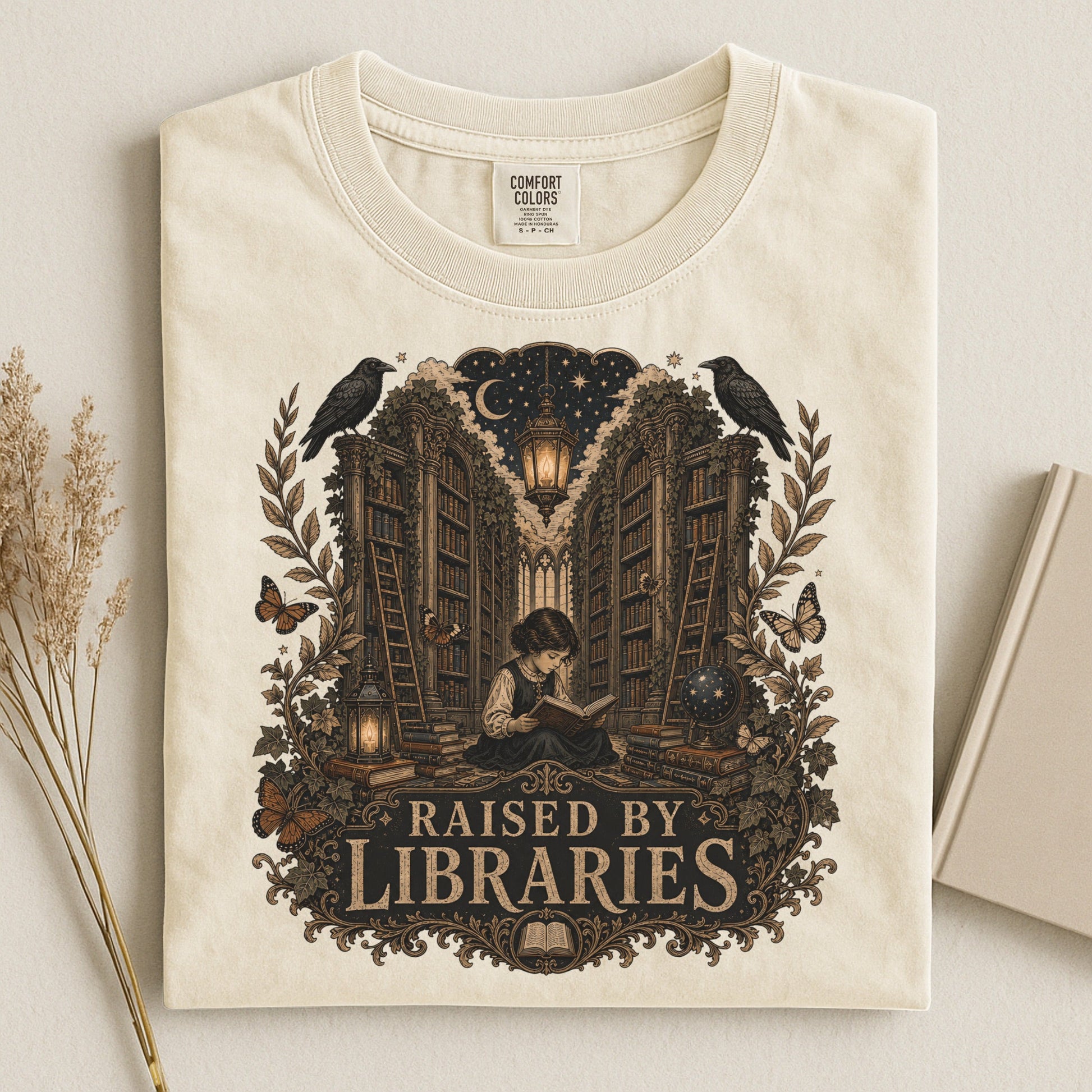 Raised by Libraries bookish tee in Ivory, flat lay