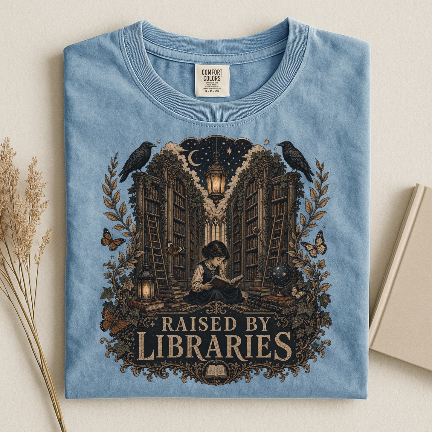 Raised by Libraries bookish tee in Ice Blue, flat lay