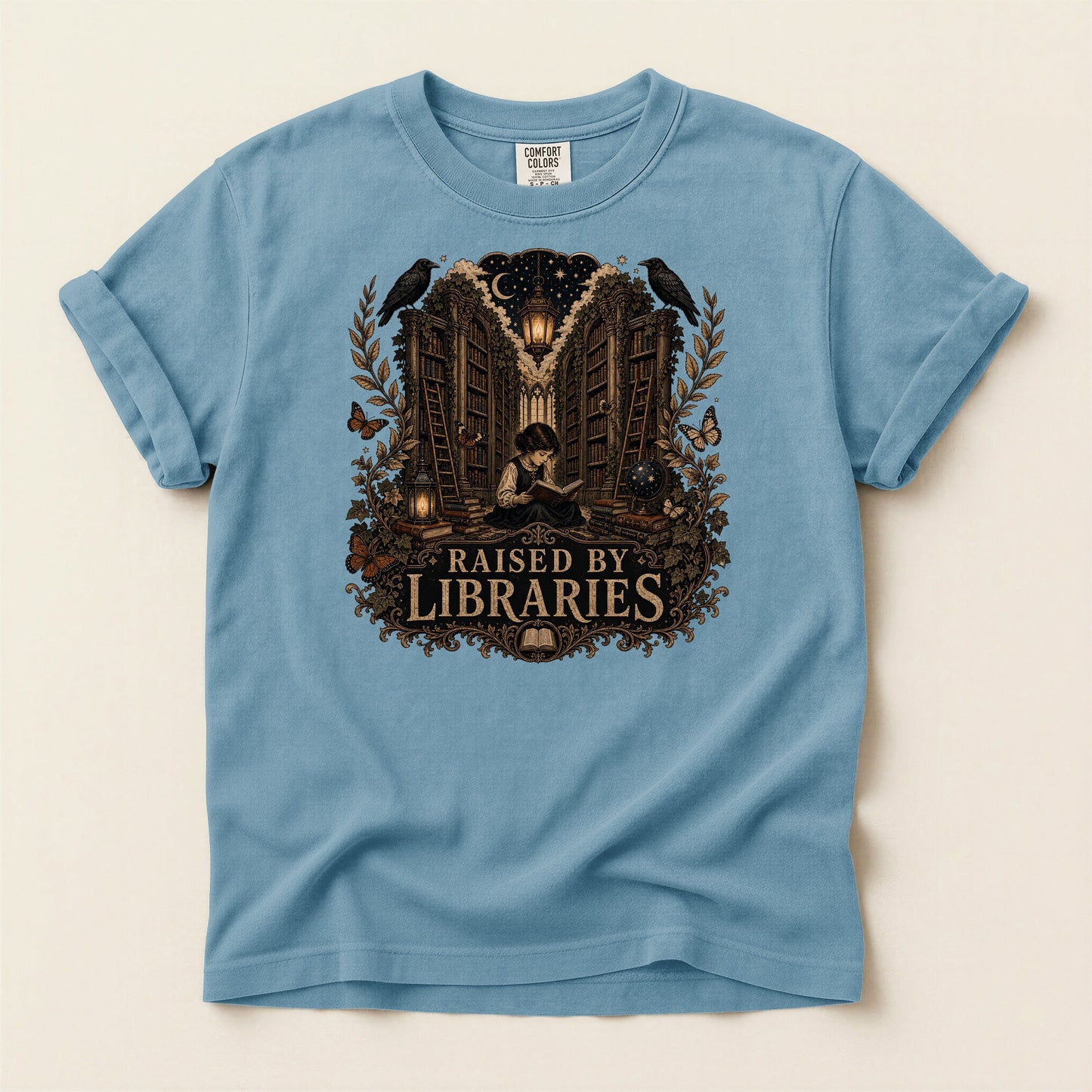 Raised by Libraries bookish tee in Ice Blue, full flat