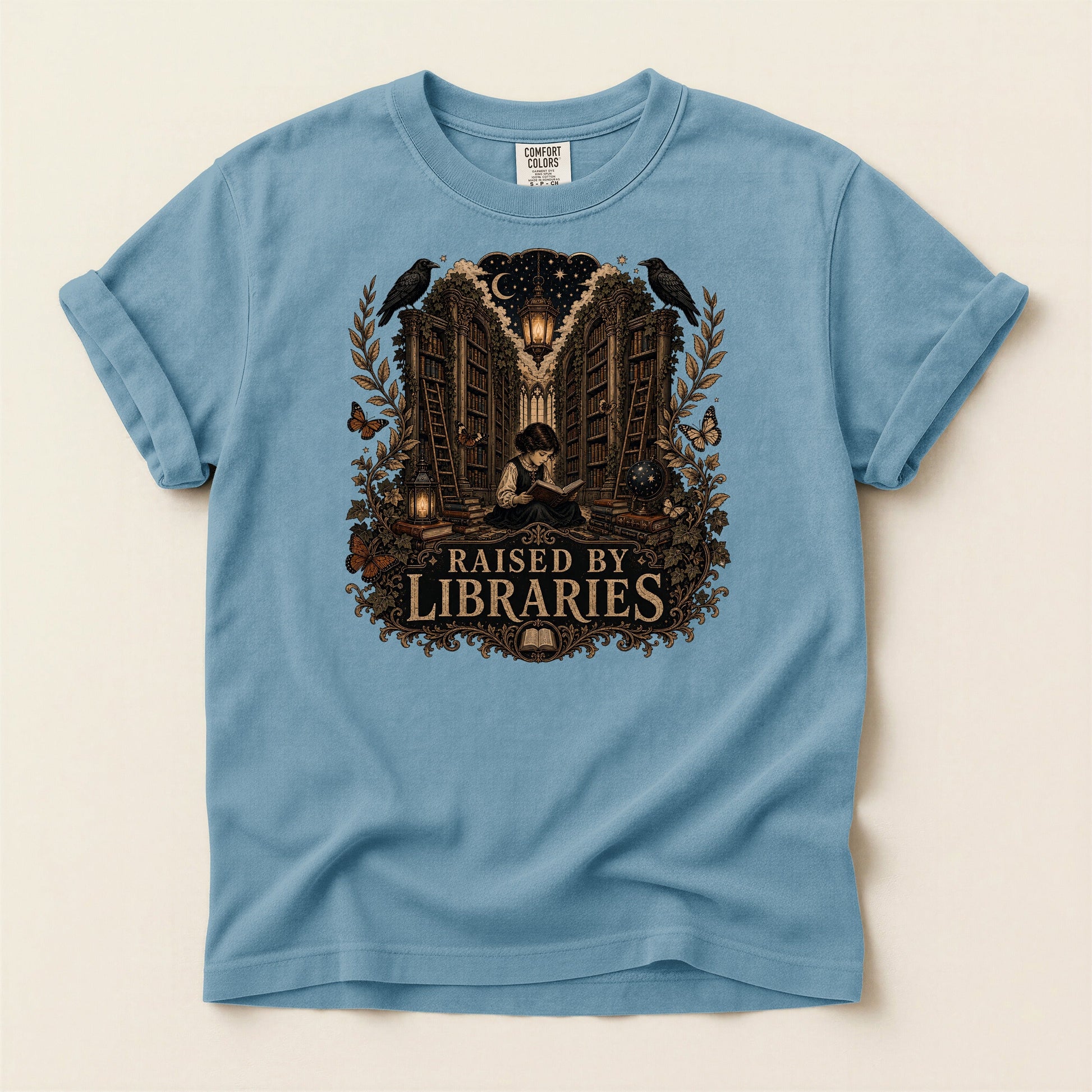 Raised by Libraries bookish tee in Ice Blue, full flat