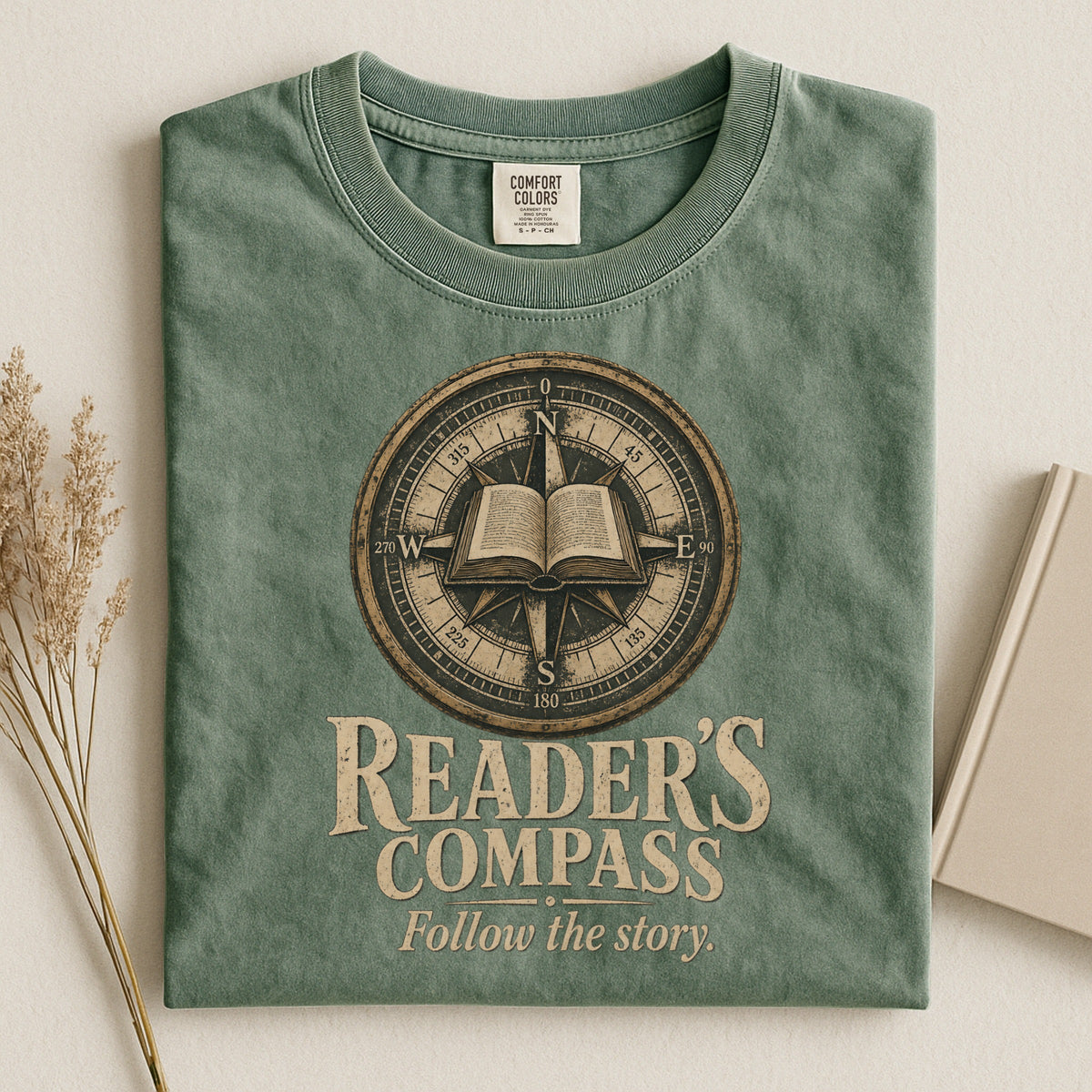 Shelf Love Studio Reader's Compass t-shirt in Moss, styled flat lay