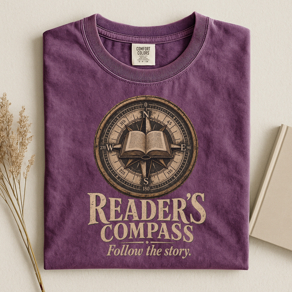 Shelf Love Studio Reader's Compass t-shirt in Berry, styled flat lay