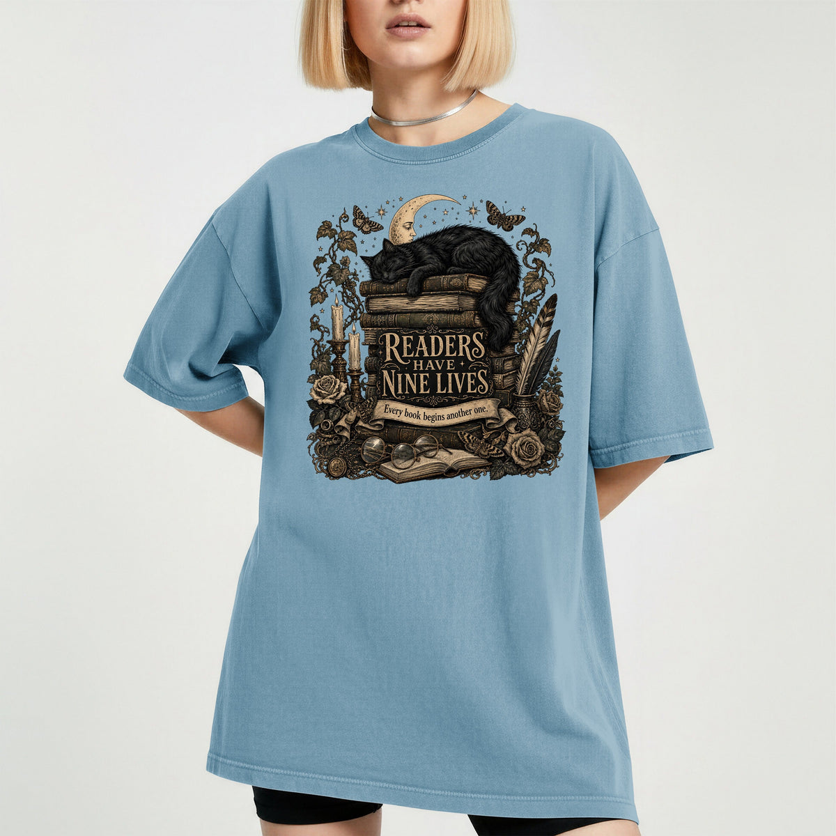 Readers Have Nine Lives bookish tee in Ice Blue, worn