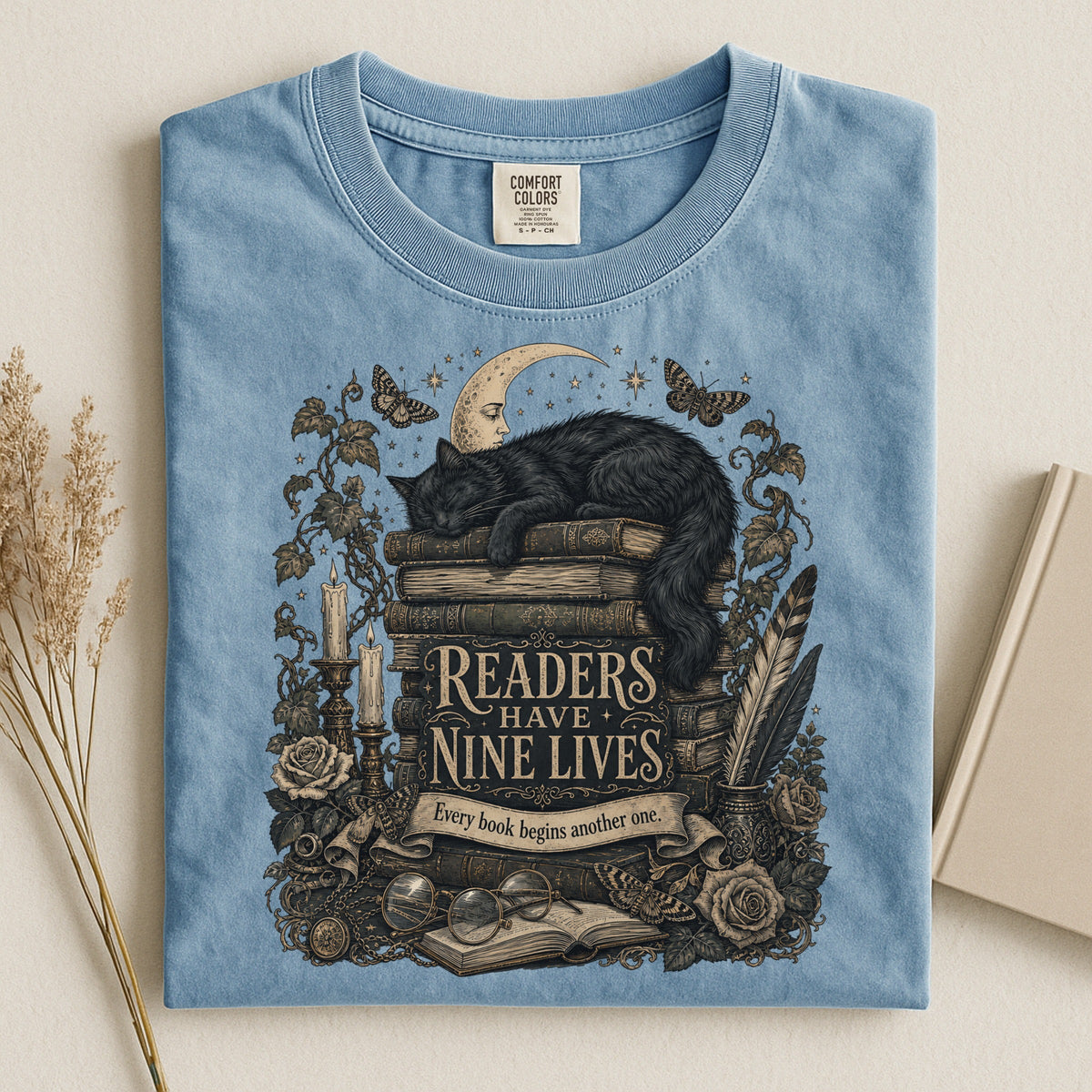 Readers Have Nine Lives bookish tee in Ice Blue, flat lay