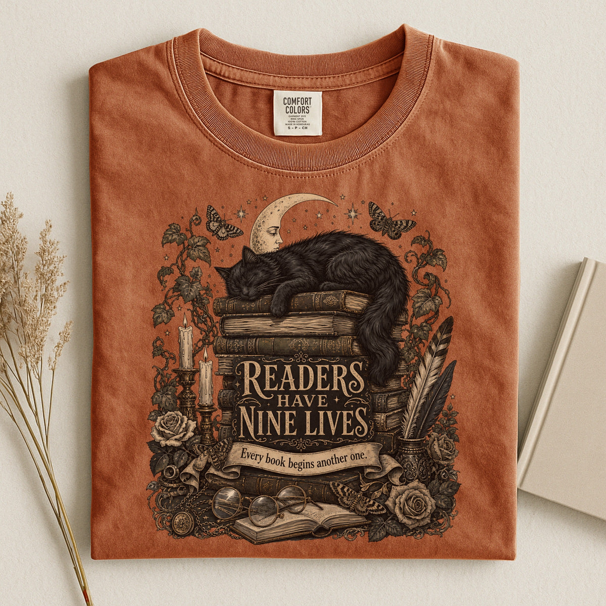 Readers Have Nine Lives bookish tee in Yam, flat lay