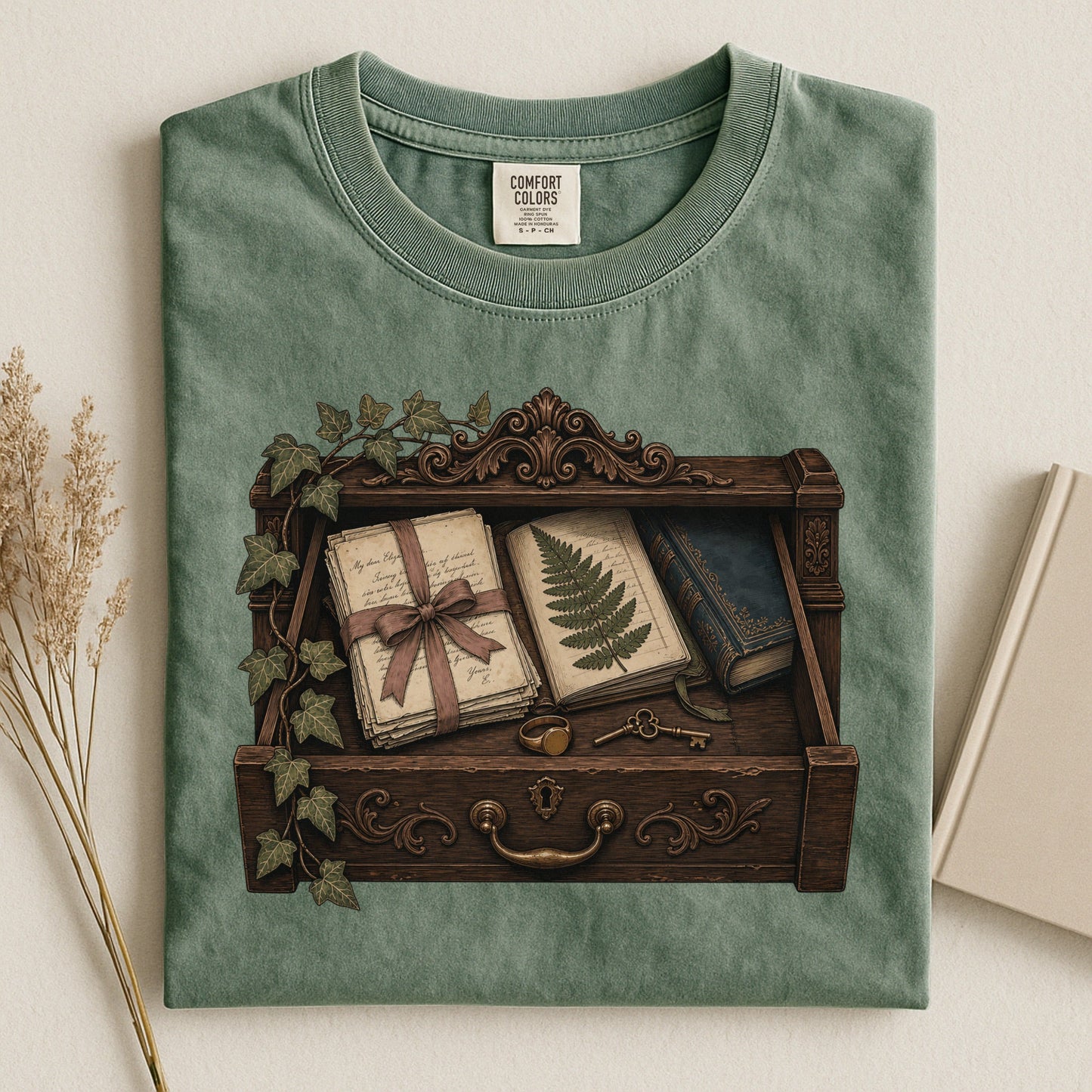 Reader's Keepsake Drawer bookish tee in Moss, flat lay