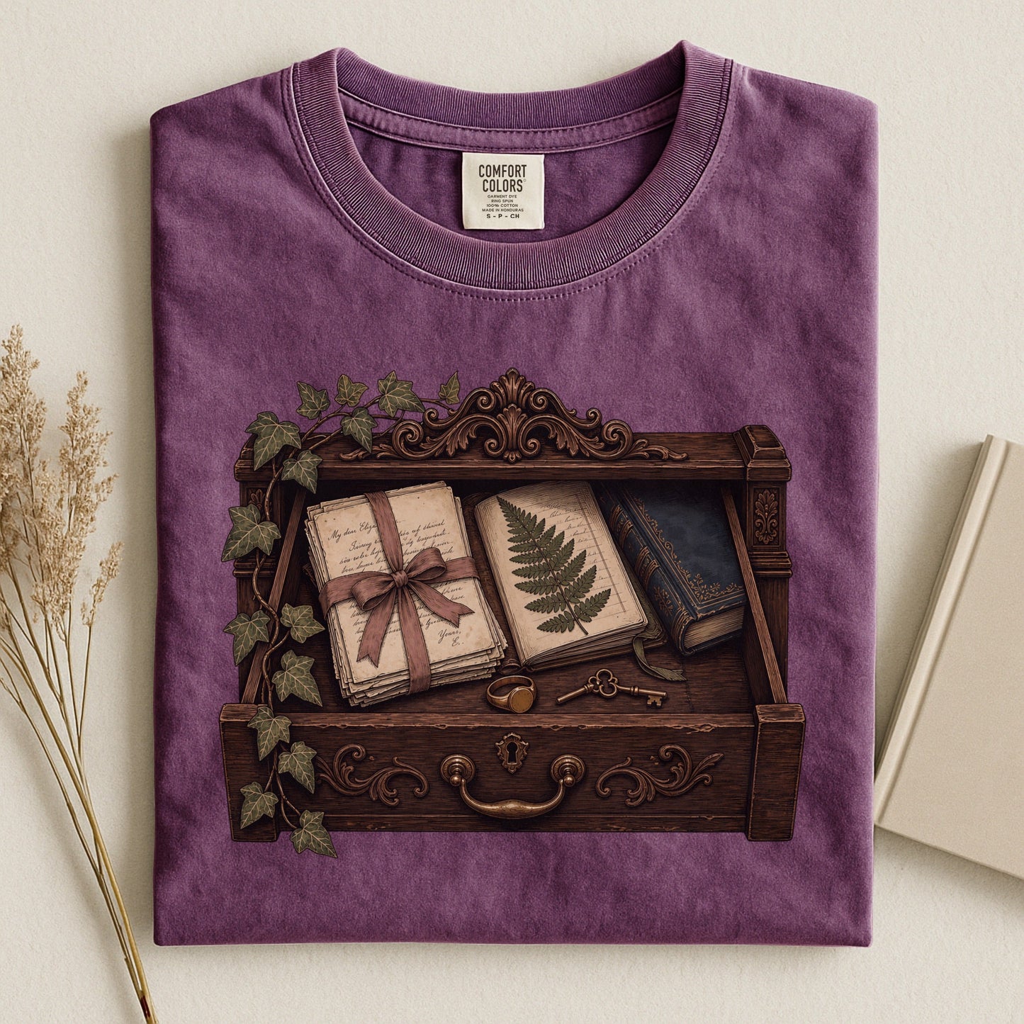 Reader's Keepsake Drawer bookish tee in Berry, flat lay