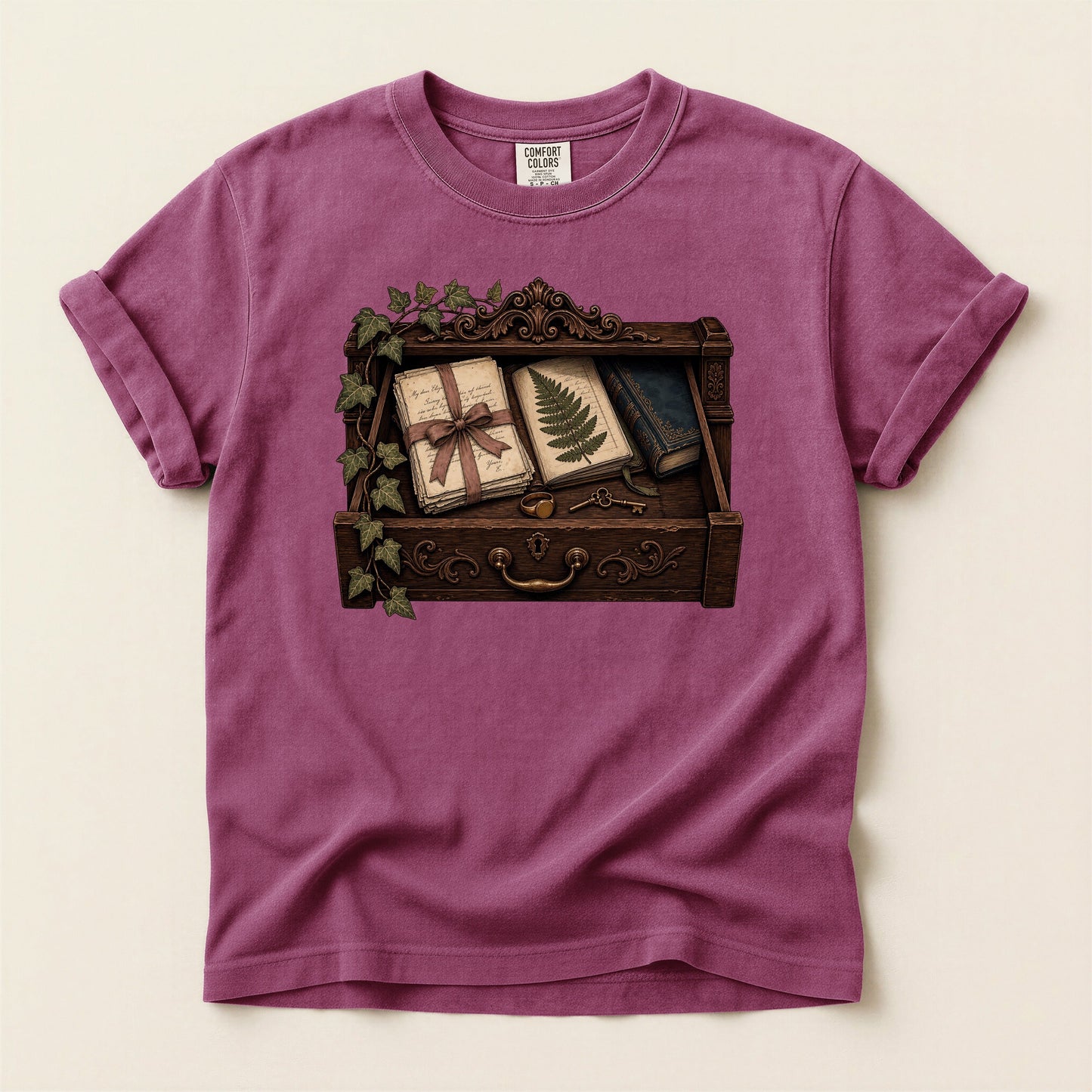 Reader's Keepsake Drawer bookish tee in Berry, full flat