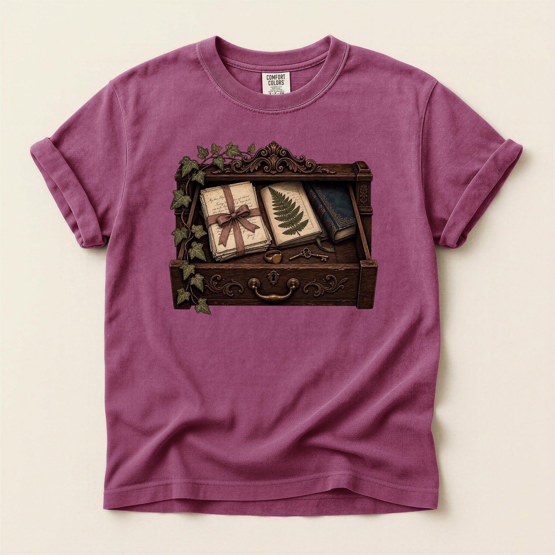 Reader's Keepsake Drawer bookish tee in Berry, full flat