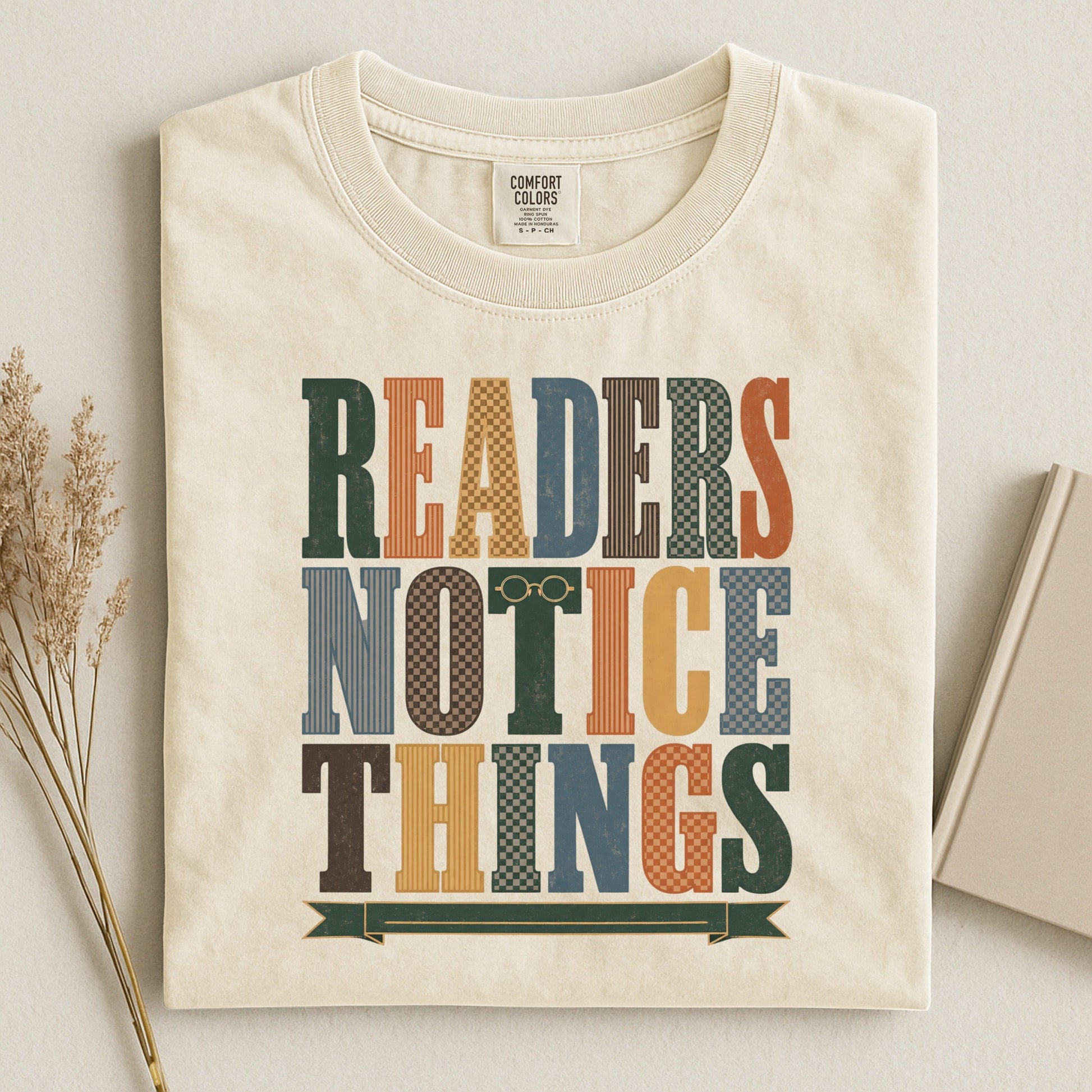 Readers Notice Things bookish tee in Ivory, flat lay