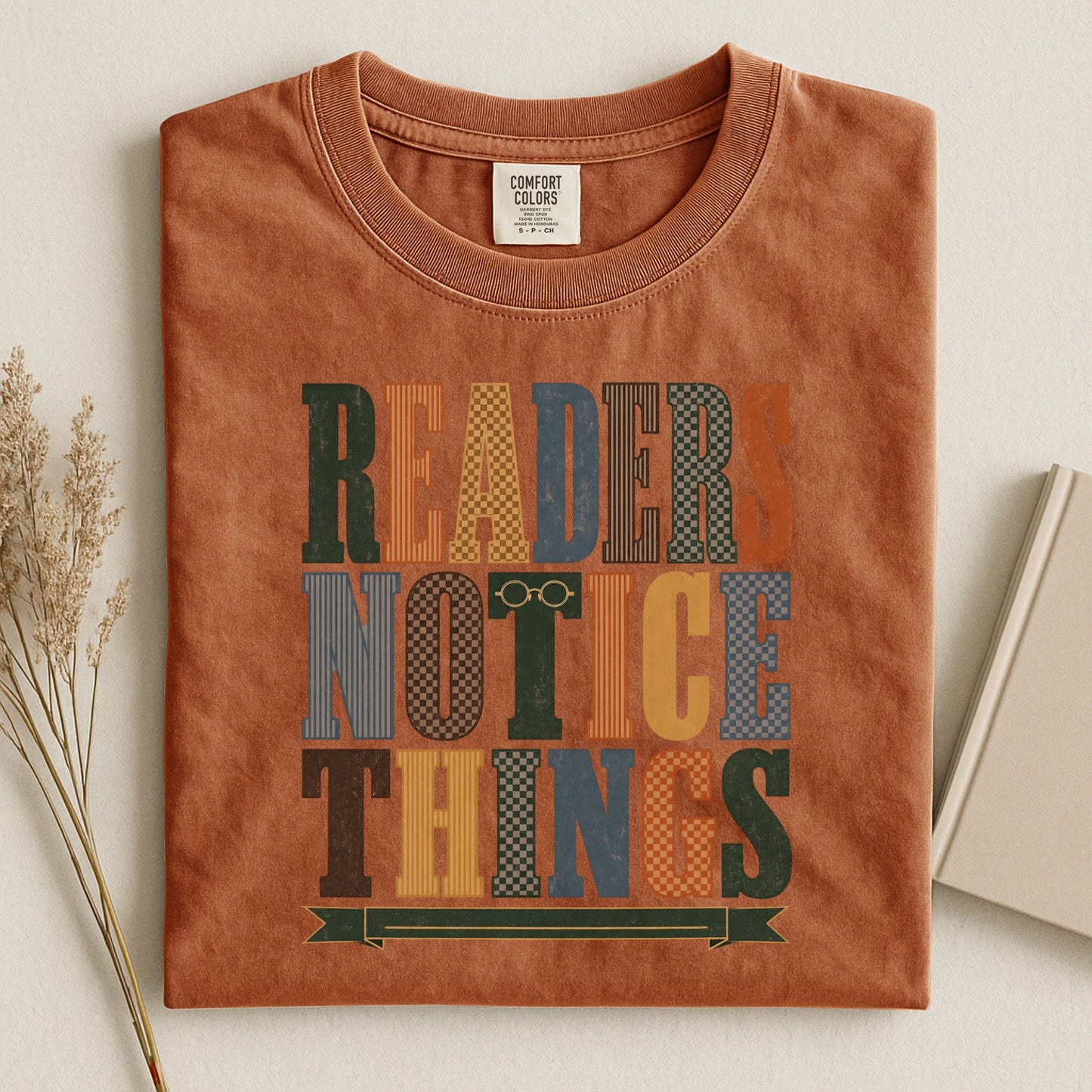 Readers Notice Things bookish tee in Yam, flat lay