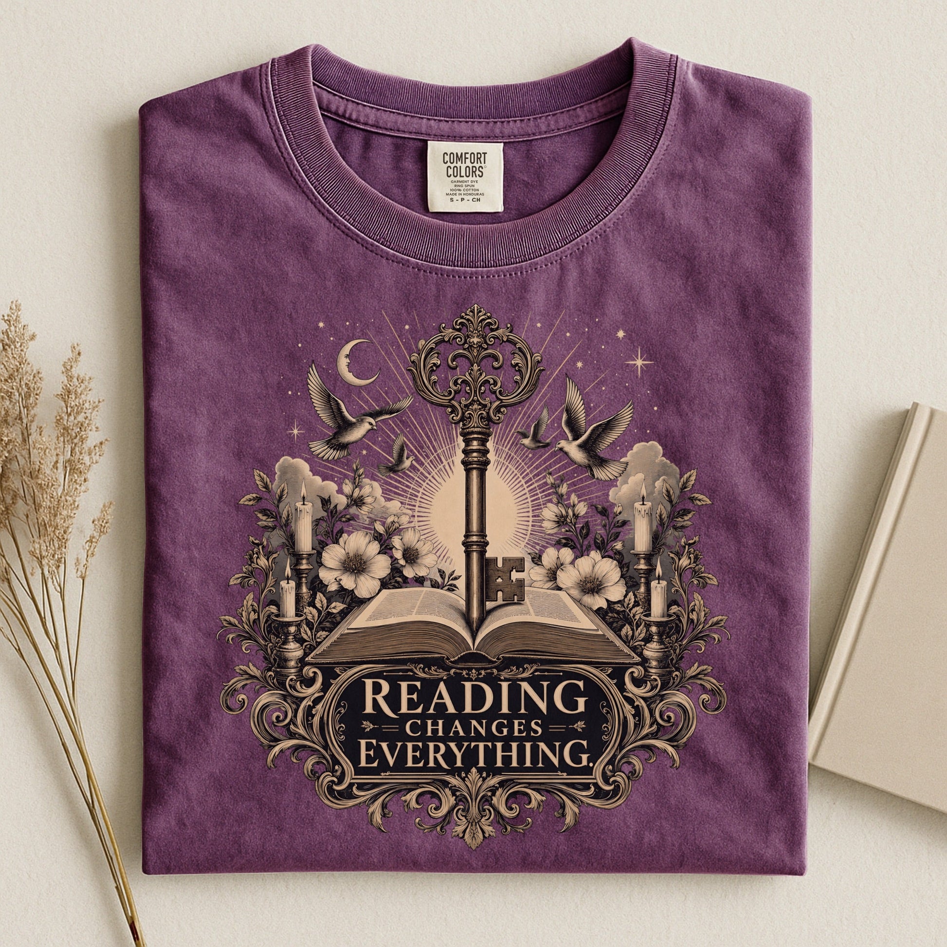 Reading Changes Everything bookish tee in Berry, flat lay