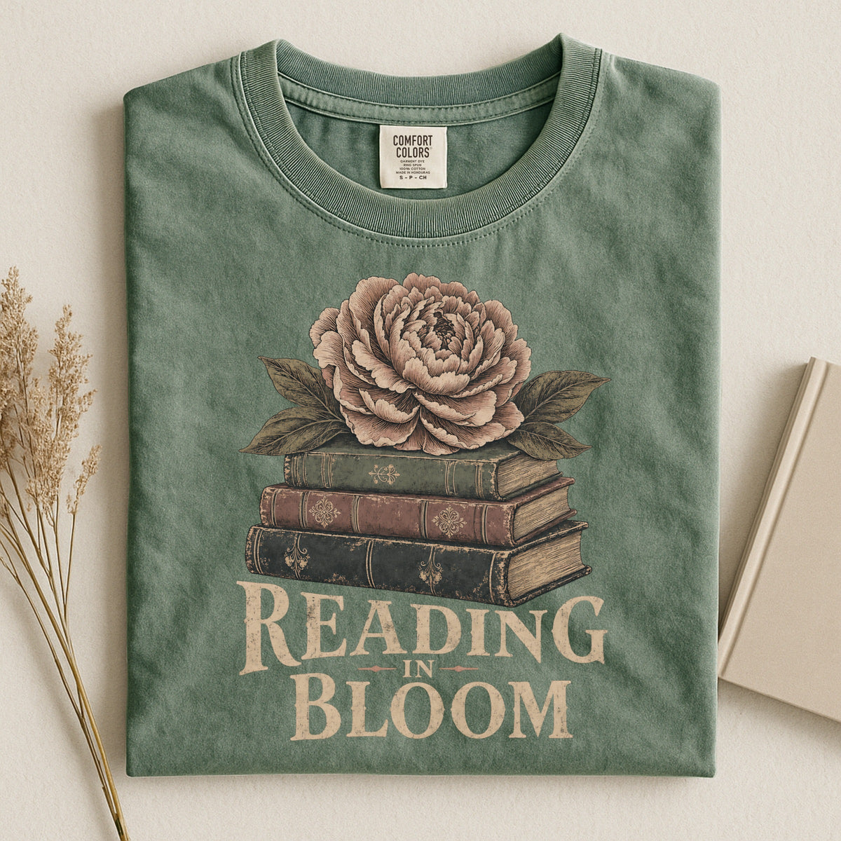 Shelf Love Studio Reading in Bloom t-shirt in Moss, styled flat lay