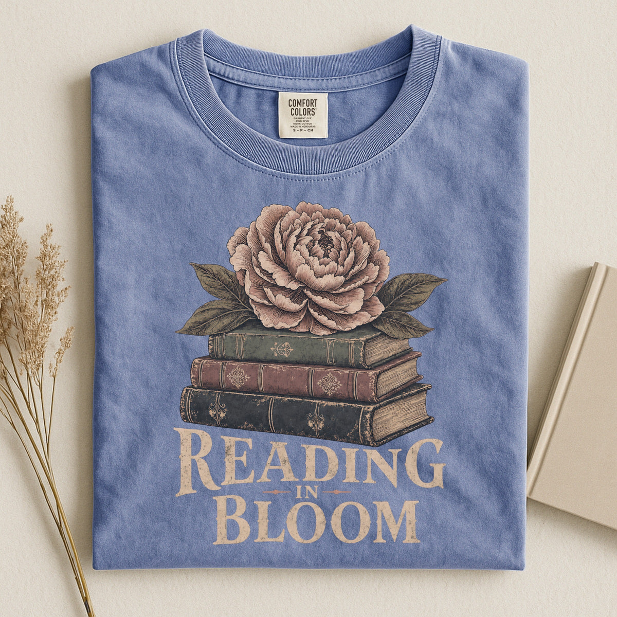 Shelf Love Studio Reading in Bloom t-shirt in Blue Jean, styled flat lay