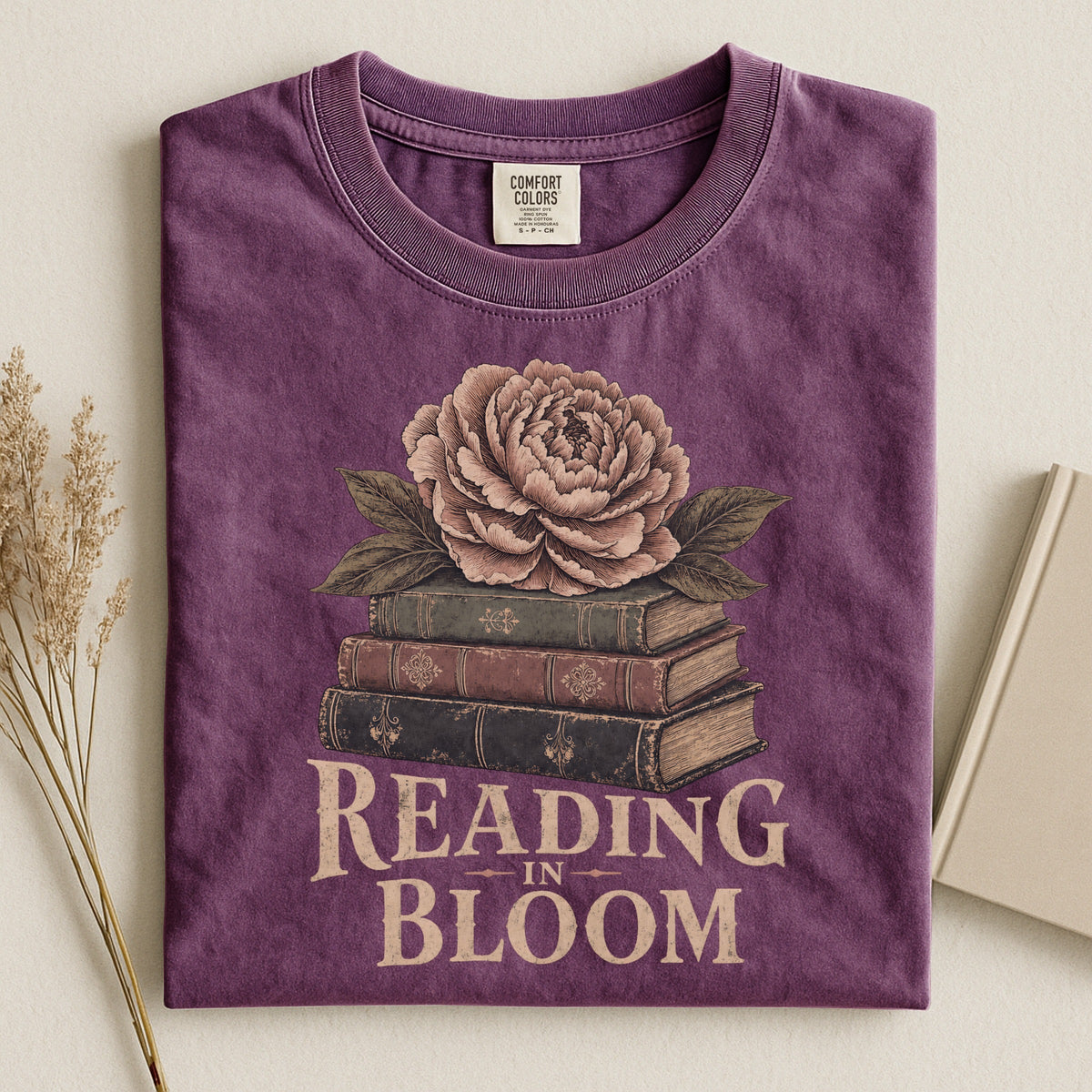 Shelf Love Studio Reading in Bloom t-shirt in Berry, styled flat lay