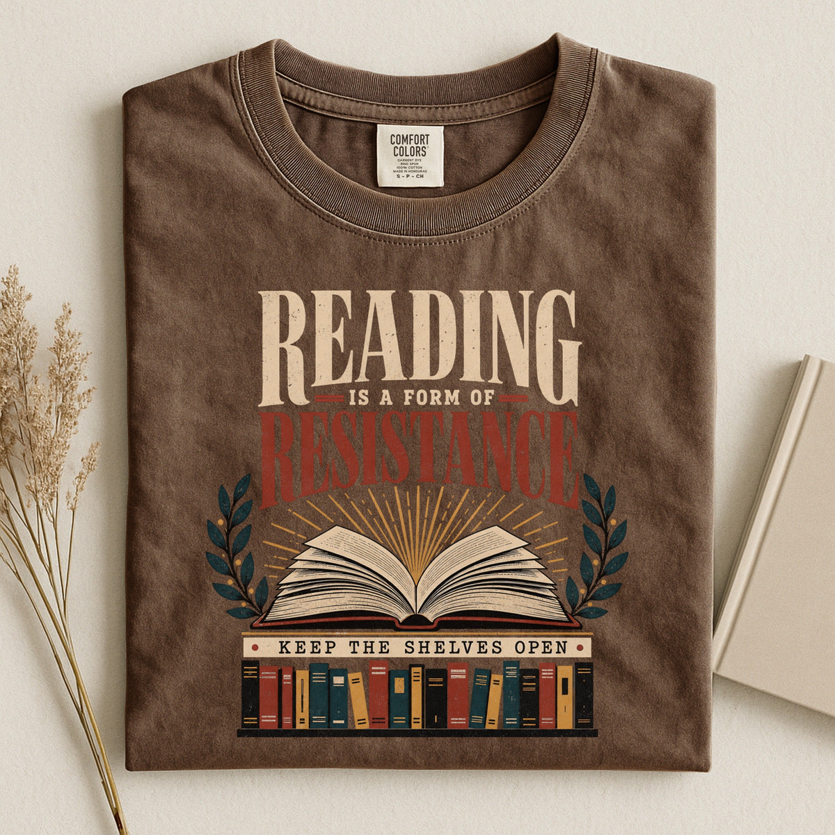 Shelf Love Studio Reading Is a Form of Resistance t-shirt in Espresso, styled flat lay