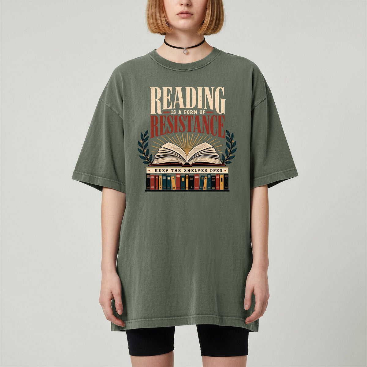 Shelf Love Studio Reading Is a Form of Resistance t-shirt in Moss, worn