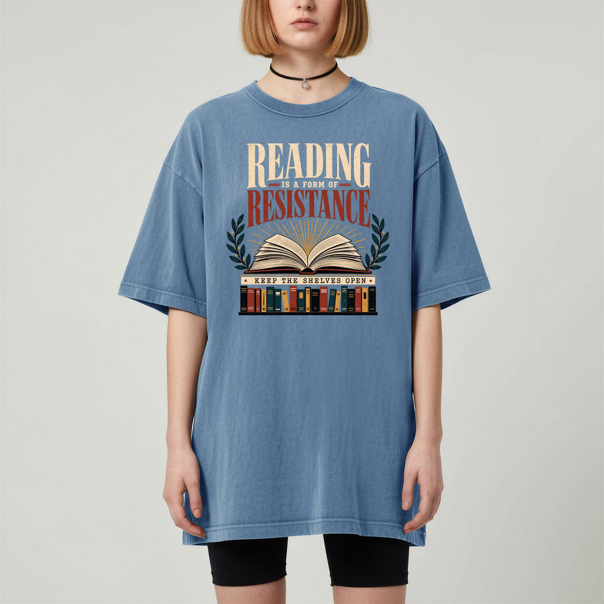 Shelf Love Studio Reading Is a Form of Resistance t-shirt in Blue Jean, worn