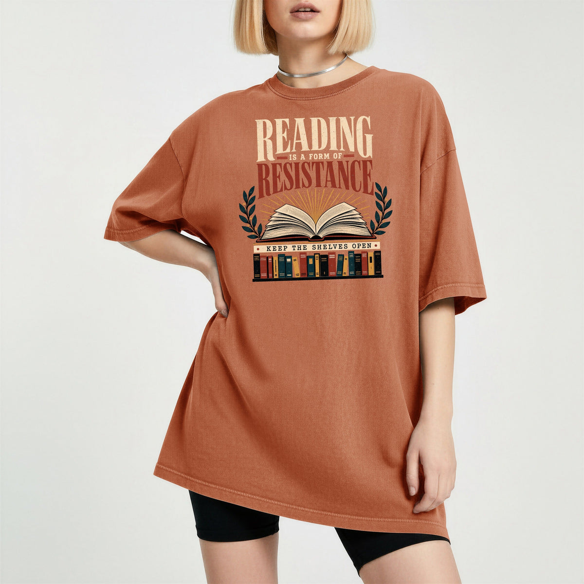Shelf Love Studio Reading Is a Form of Resistance t-shirt in Yam, worn
