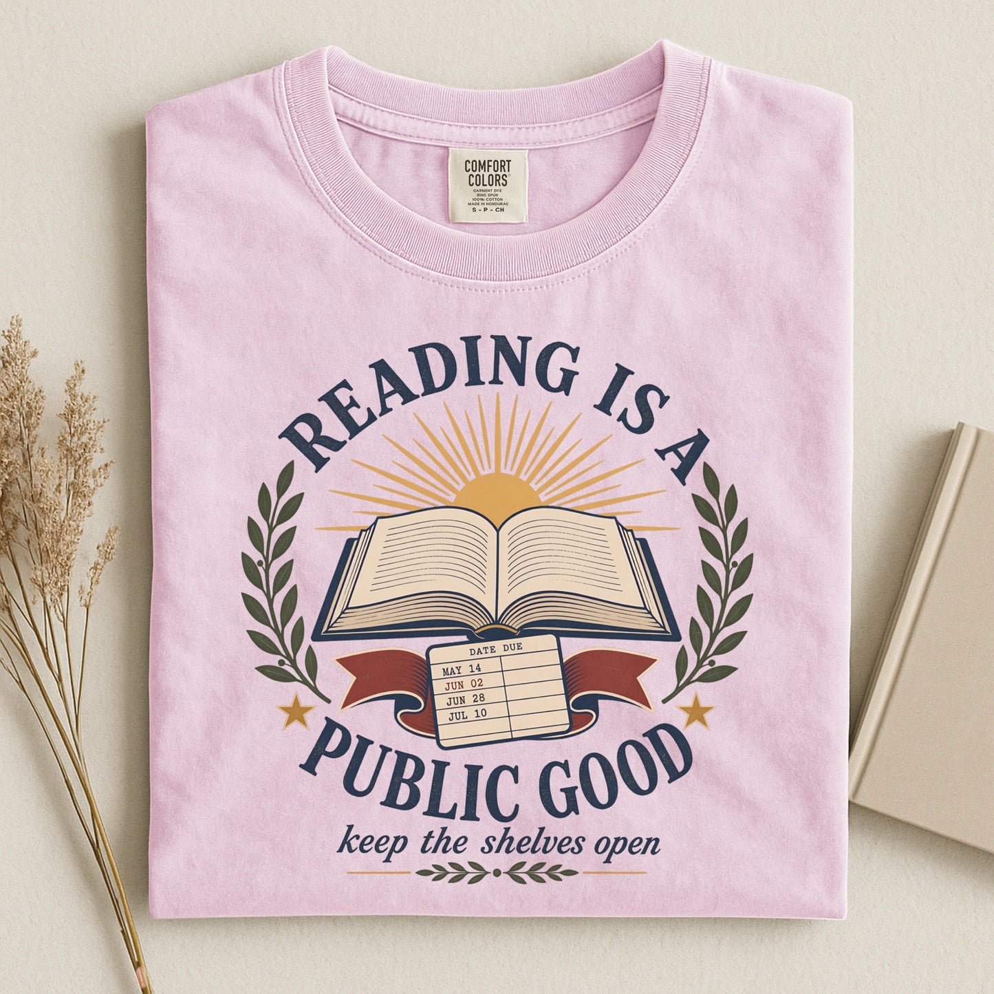 Reading Is a Public Good bookish tee in Blossom, flat lay